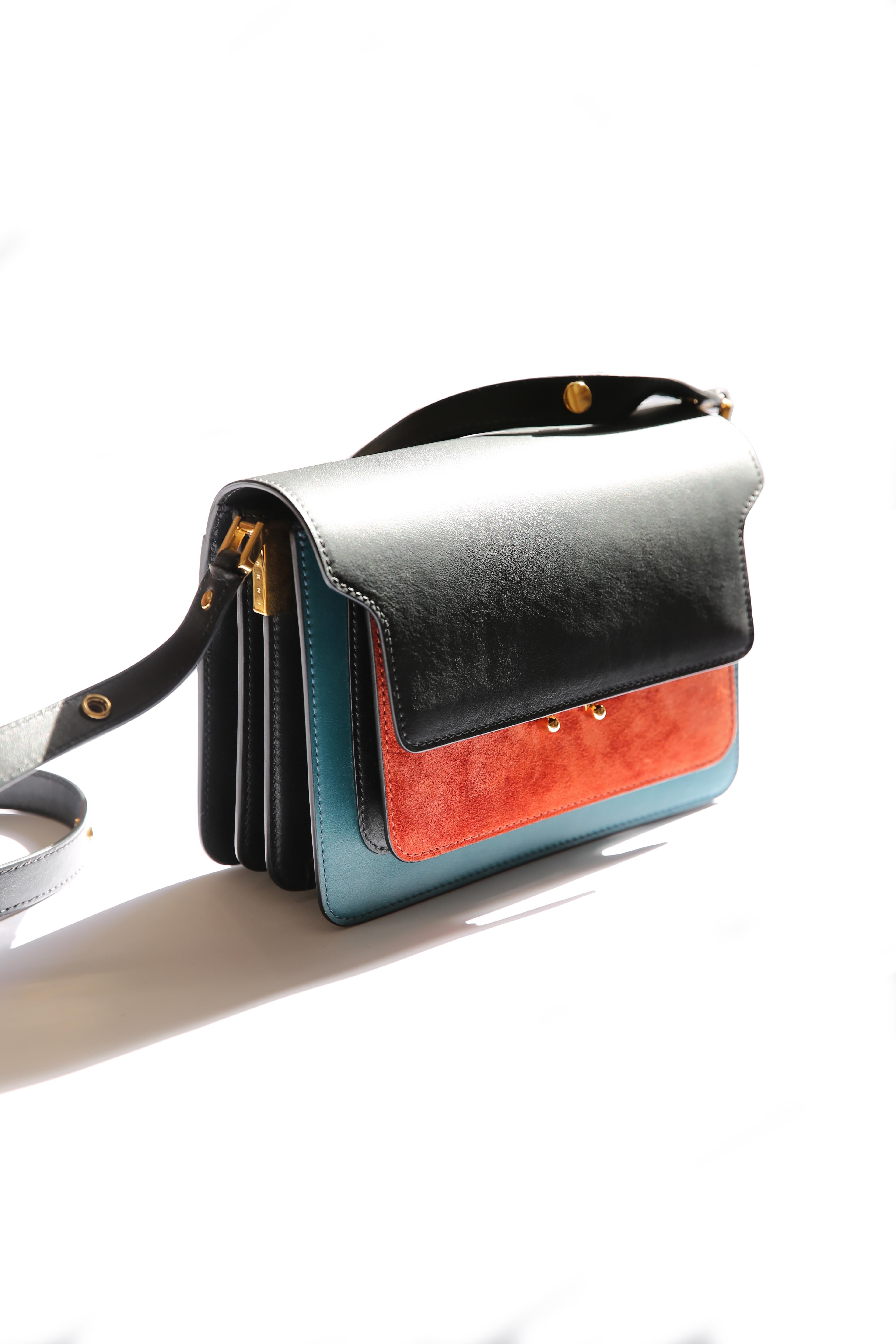 LOVE LALI Vintage

Limited edition Marni trunk shoulder color block bag in smooth black and teal leather and rust coloured suede
This structured piece with gusseted sides is roomier than you might expect, featuring two zipped pouches along with four