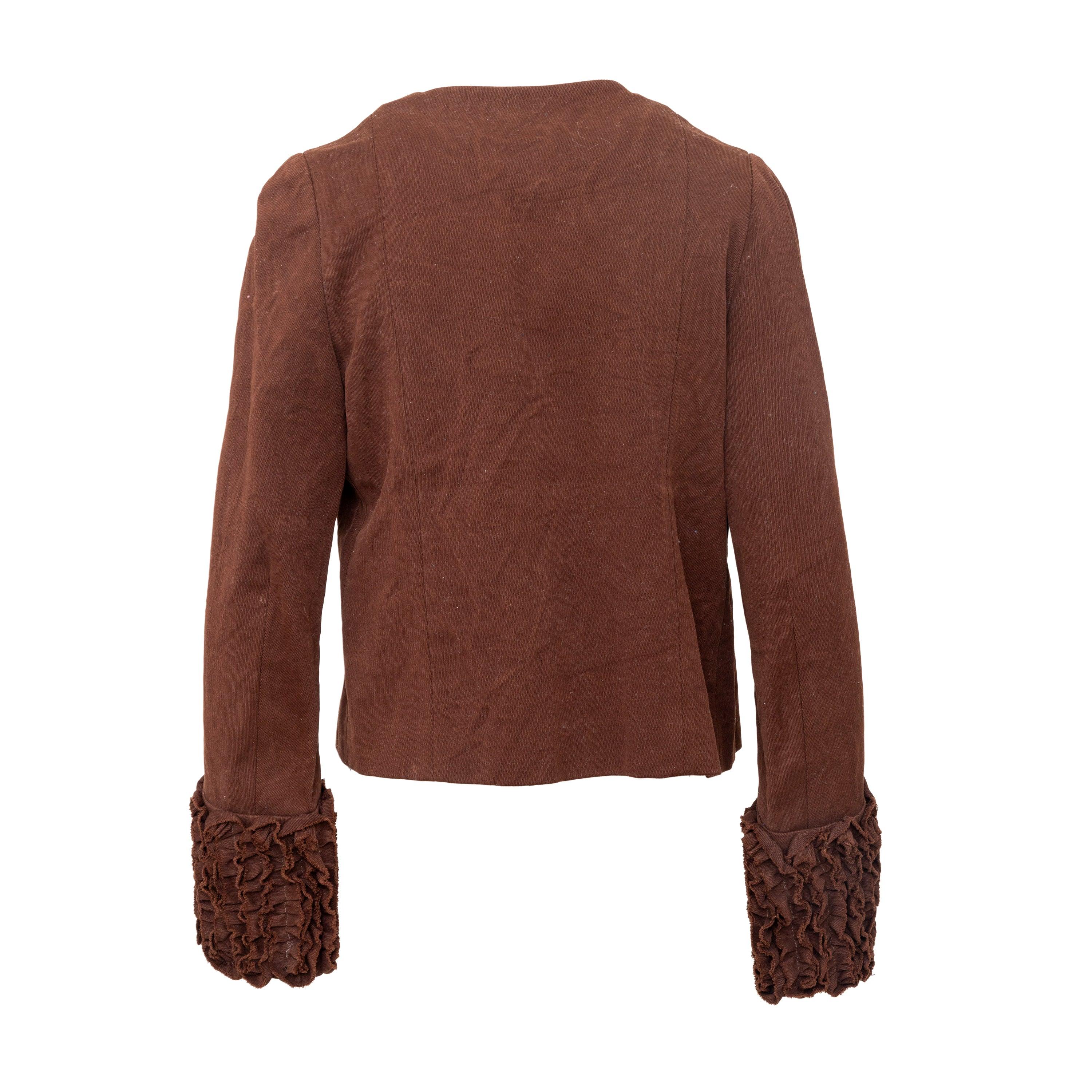 Realizzata con maestria in twill di misto cotone, questa giacca Marni vanta una bellissima tonalità marrone scuro. Con un design aperto sul davanti, la giacca presenta un accento di ruches sull'orlo e sul davanti che eleva il design. Sfoderato per