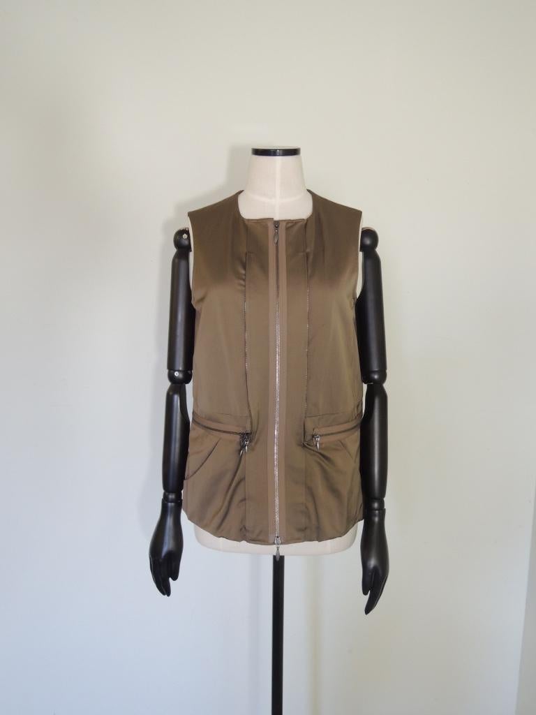 This is a Marni jacket with zip-in sleeveless vest. The color is a military green. Note the gathering at the cuffs and collar area.

The jacket is composed of Cotton and Polyester. 
Made in Italy. Tagged a size 42.

This is in excellent pre-owned