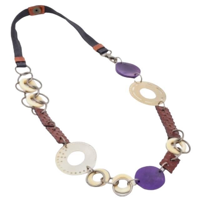 What a beauty is this Marni necklace! This two-toned metal creation is beautifully embellished with leather trims, wood accents, and beads. Wear this chain-link necklace with your summer maxi dresses and make a lasting impression.