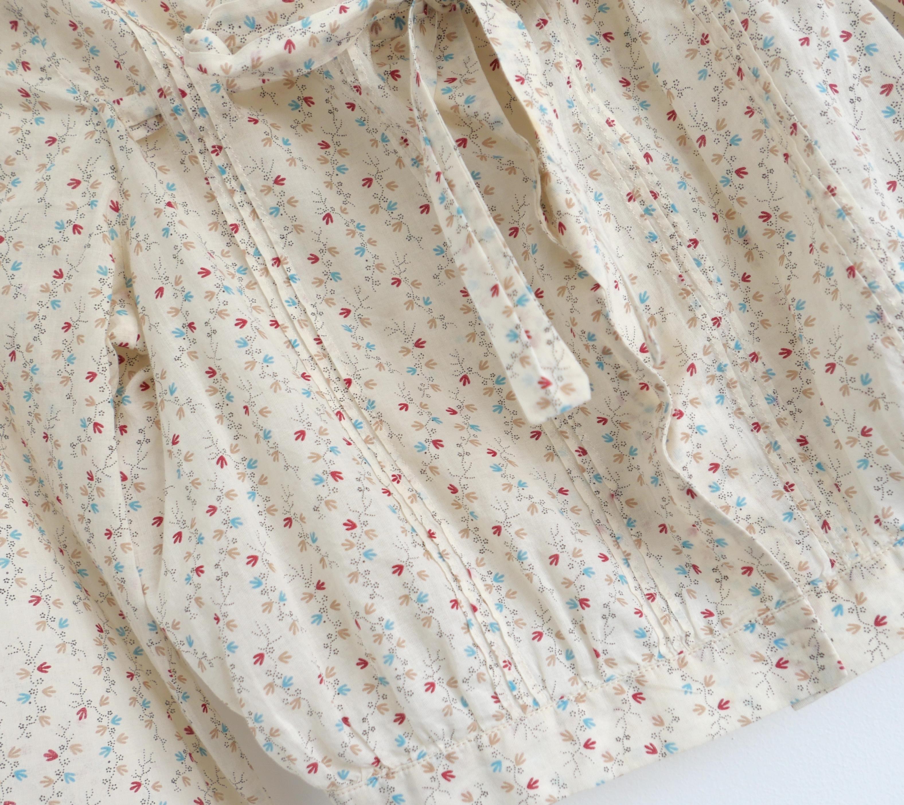 Vintage Marni peasant blouse from the SS02 collection. Made from soft cream cotton with a delicate stylised leaf bud print, it has pin tucked detailing to front and back, square neckline, cropped hem, ties to front of bust and tapered wrist length