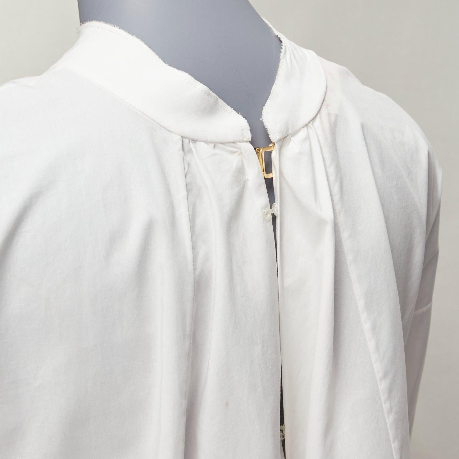 MARNI white cotton minimal front gold hook back panelled white shirt
Reference: NKLL/A00170
Brand: Marni
Material: Feels like cotton
Color: White, Gold
Pattern: Solid
Closure: Hook & Bar
Extra Details: Hook and bar back