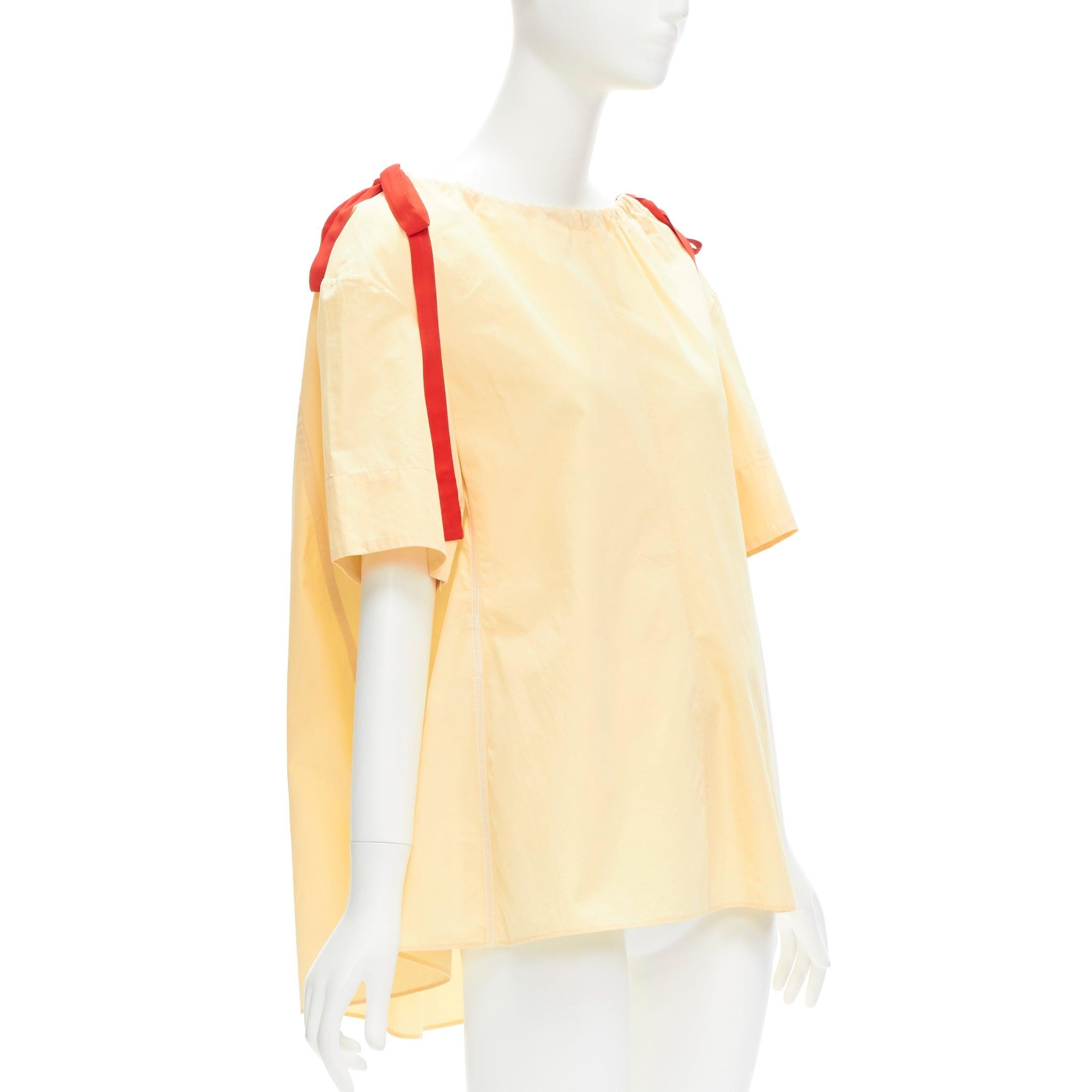 MARNI yellow 100% cotton red drawstring collar trapeze flared top IT36 XXS
Reference: CELG/A00322
Brand: Marni
Material: Cotton
Color: Yellow, Red
Pattern: Solid
Closure: Drawstring
Extra Details: Red drawstring collar design.
Made in: