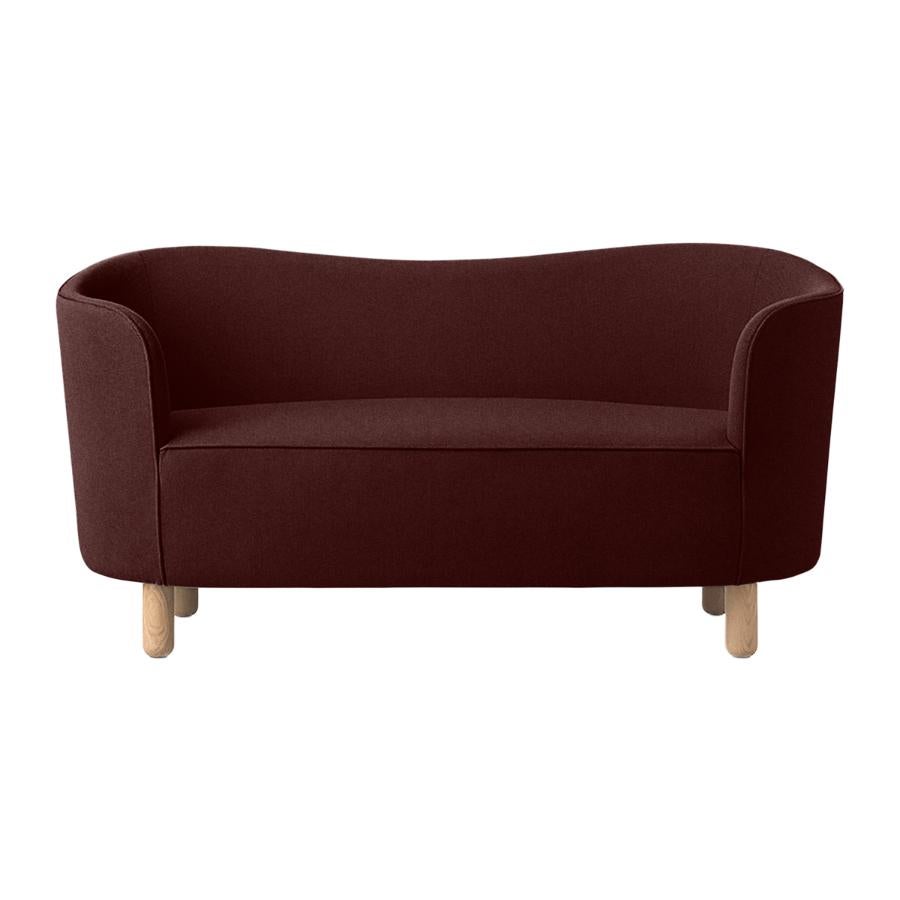 Maroon and natural oak Raf Simons Vidar 3 mingle sofa by Lassen.
Dimensions: W 154 x D 68 x H 74 cm. 
Materials: Textile, Oak.

The Mingle sofa was designed in 1935 by architect Flemming Lassen (1902-1984) and was presented at The Copenhagen