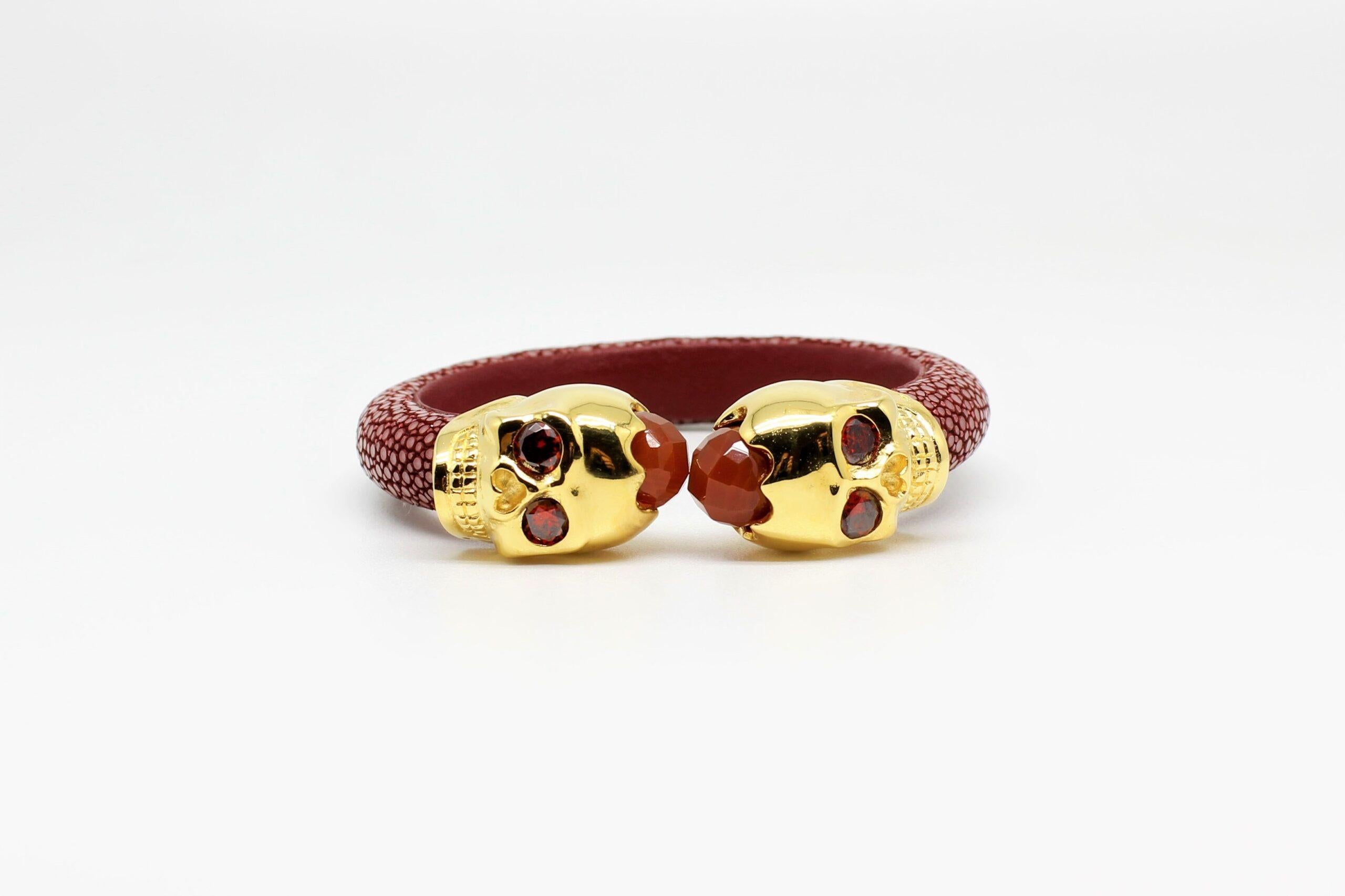 Maroon Galuchat Skin Bangle Bracelet with Skull Gold-Plated and Coral Stones by Ninety, Spain. 
Galuchat or Shagreen, skin of the stingray, became famous in Europe during the reign of Louis XV. 
Originally used as veneer on a variety of courtly