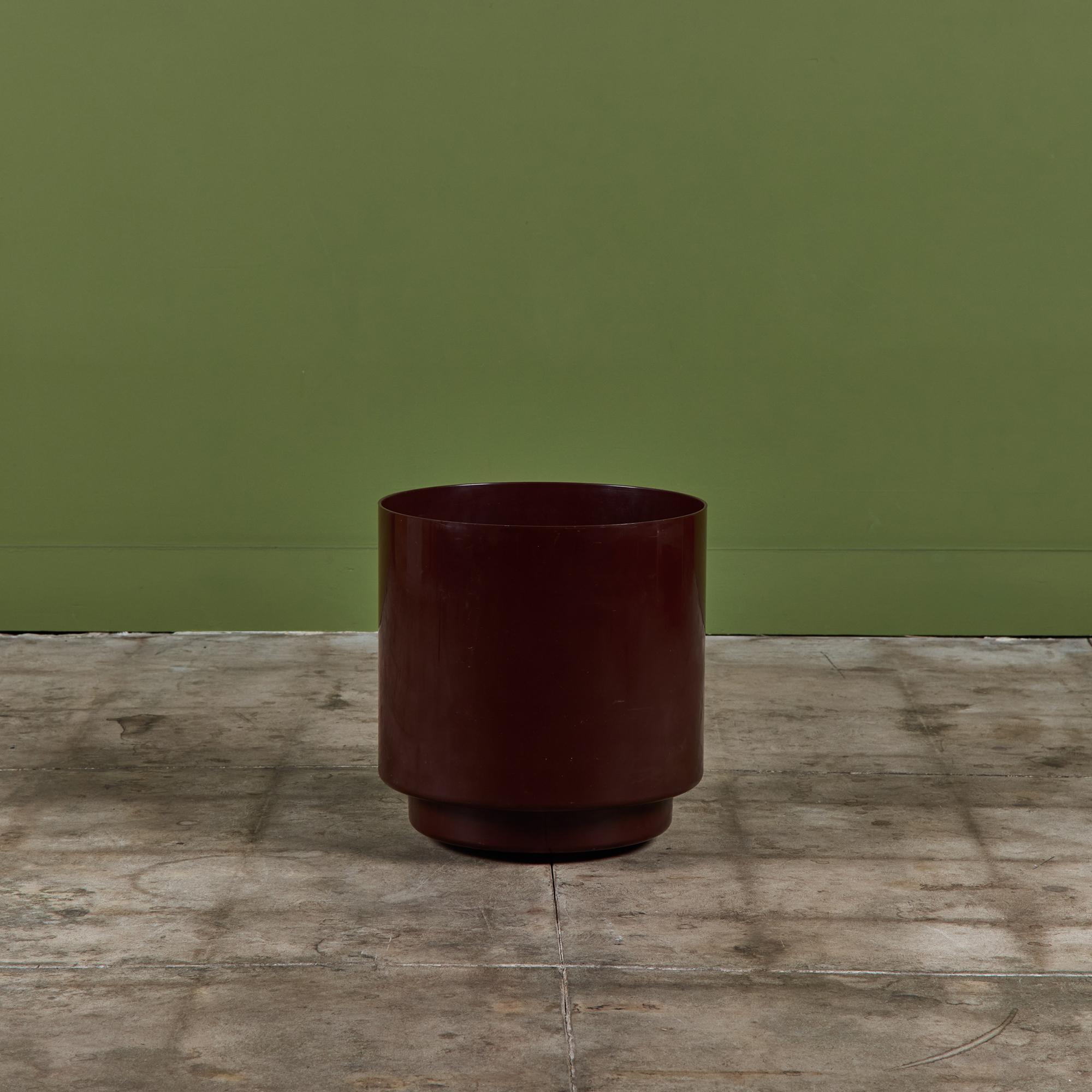Planter from Italian design house Kartell, designed by Anna Castelli Ferrieri, c.1970s, USA. The maroon planter features a cylindrical plastic form with four casters at the bottom.
Six available, priced individually.

Dimensions
16.25” diameter x