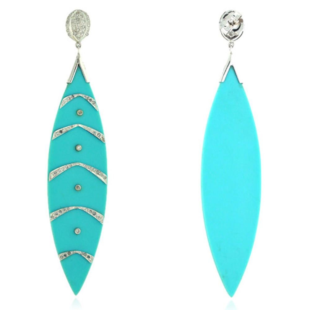 Long and alluring this turquoise color bakelite earring is 4 inch long with white diamond pave work on 14K white gold is a stunning earring for summers.

Closure: Push Post

14K: 8.82gms
Diamond: 1.670cts
Bakelite: 32.00cts