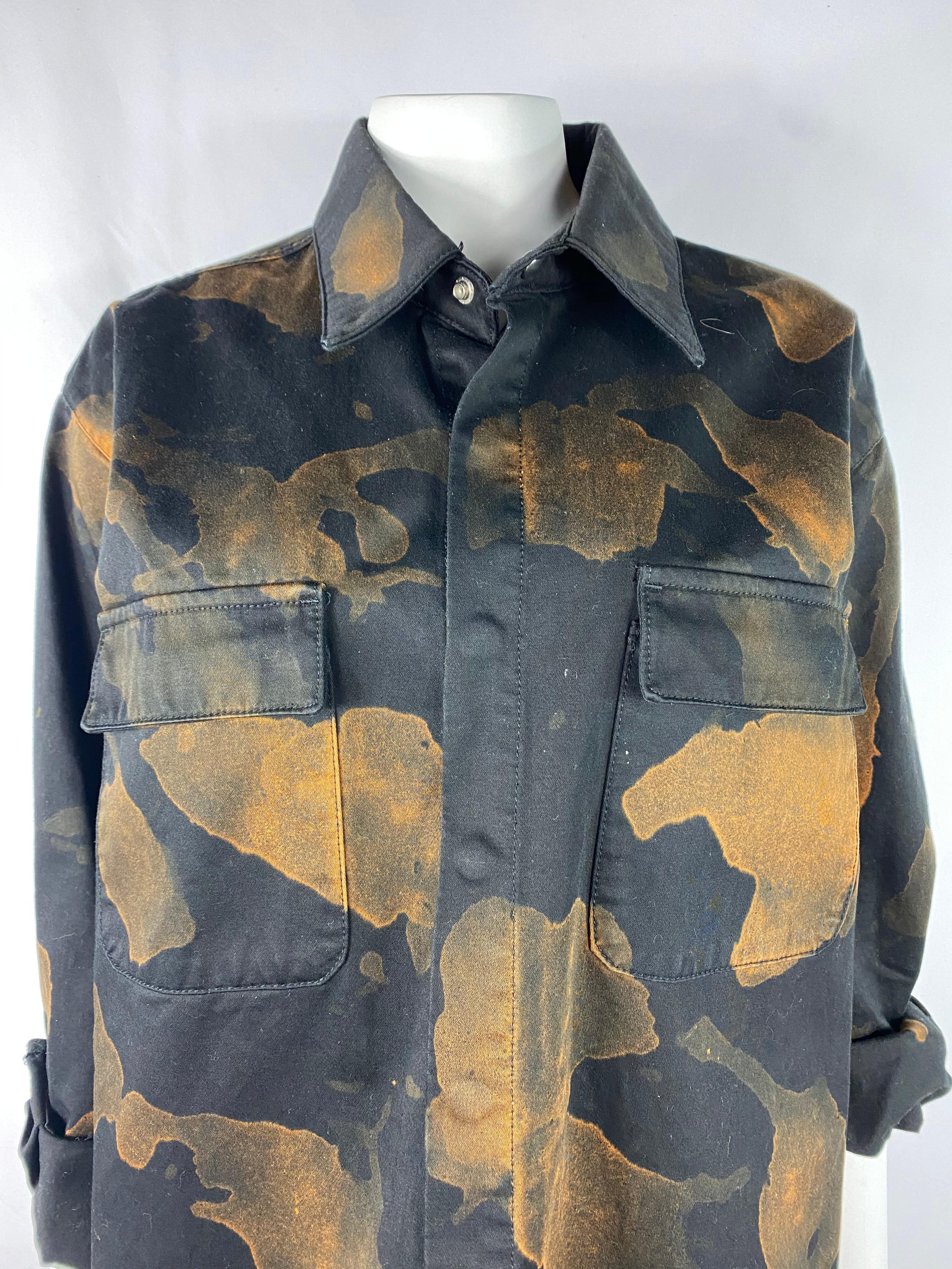 Product details:

Featuring 100% cotton black button down shirt with brown/ yellow abstract print, collar and dual front pocket detail. Oversized fit.