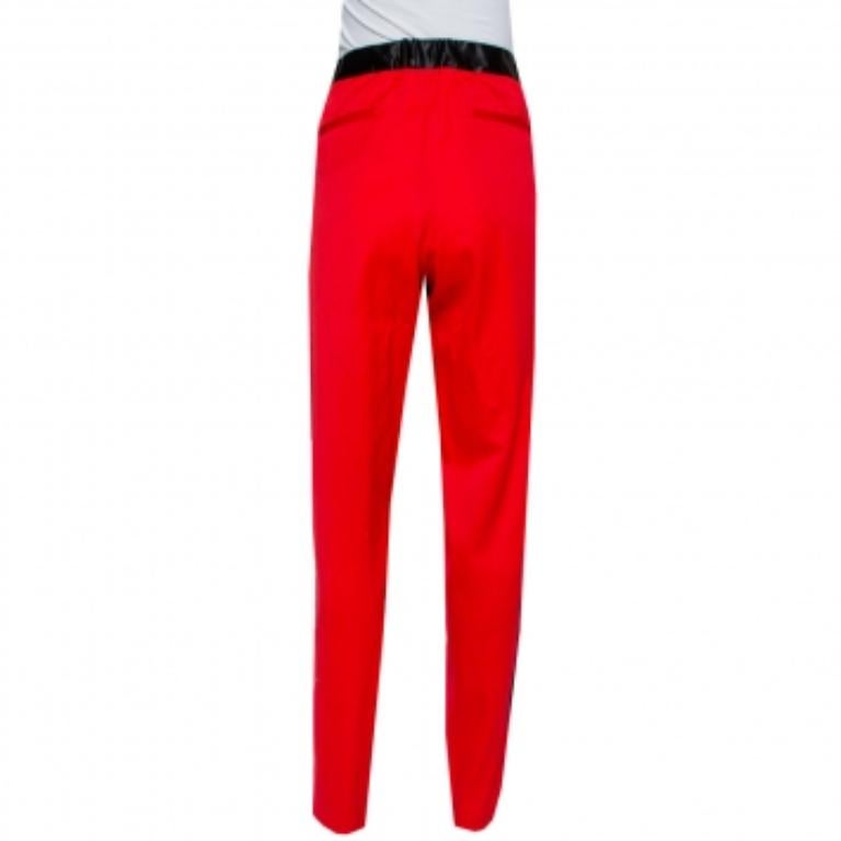 A work-from-home or stay-at-home fashion staple, track pants are the ultimate comfort clothing to wear these days. This pair is by Marques Almeida. Made from wool, the red pair features contrast trims and zippers on the sides, three pockets, and a