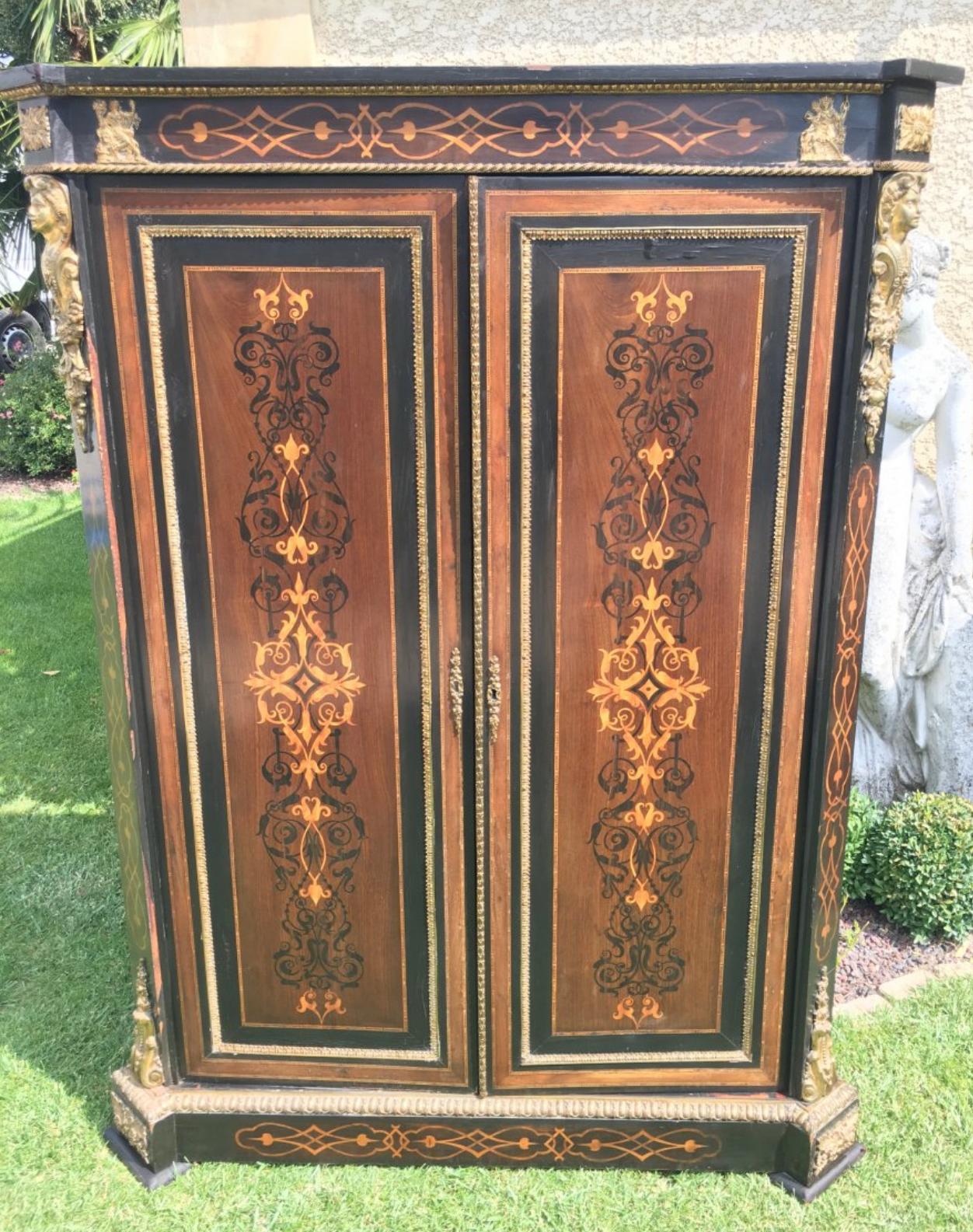 Very pretty cupboard in marquetry and gilded bronze Napoleon III opening with two doors The two doors have pretty decorative patterns French work XIX century Some small chips of veneer require a small restoration of use.
