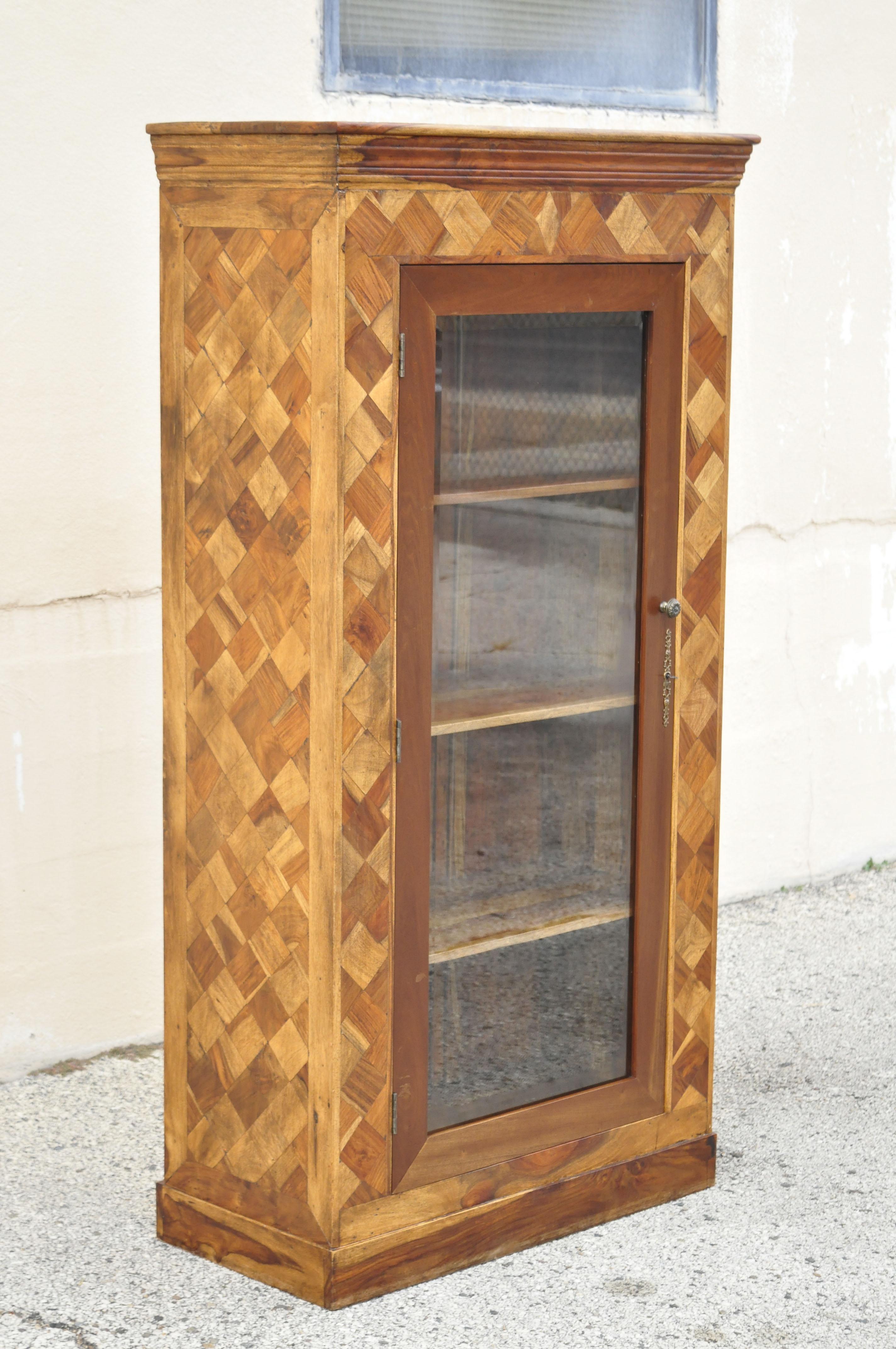 Marquetry geometric inlay mixed wood one drawer bookcase display cabinet curio. Item features stunning marquetry inlay wooden case, with diamond cut geometric pattern, solid wood construction, beautiful wood grain, 1 glass swing door, working lock