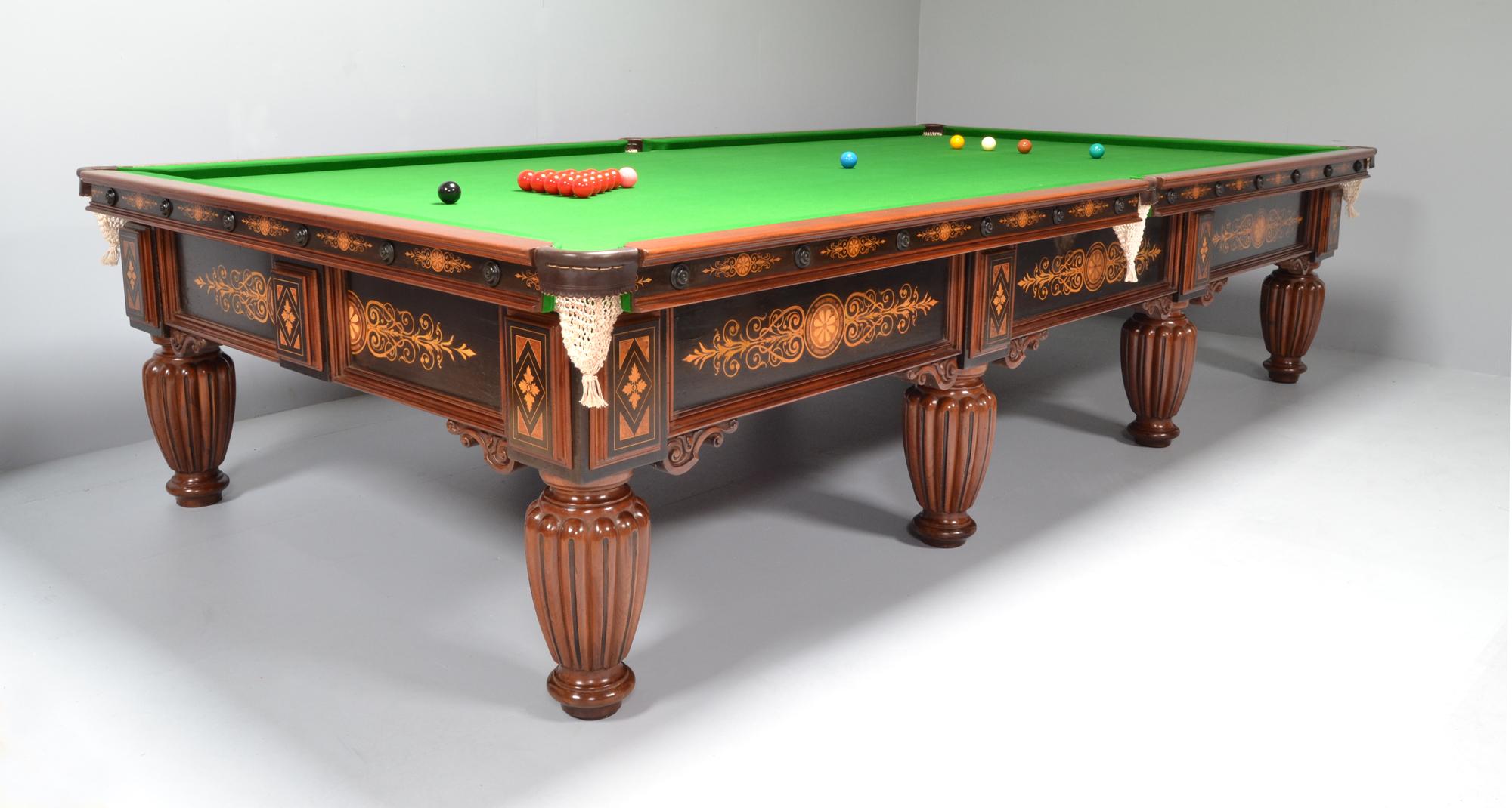 A fabulous full size 12ft x 6ft mahogany and ebony marquetry billiard table, English circa 1875.

The side frame is embellished with decorative marquetry roundels and flowing symmetrical fauna of Boxwood and Amboyna, the cushions sides follow this