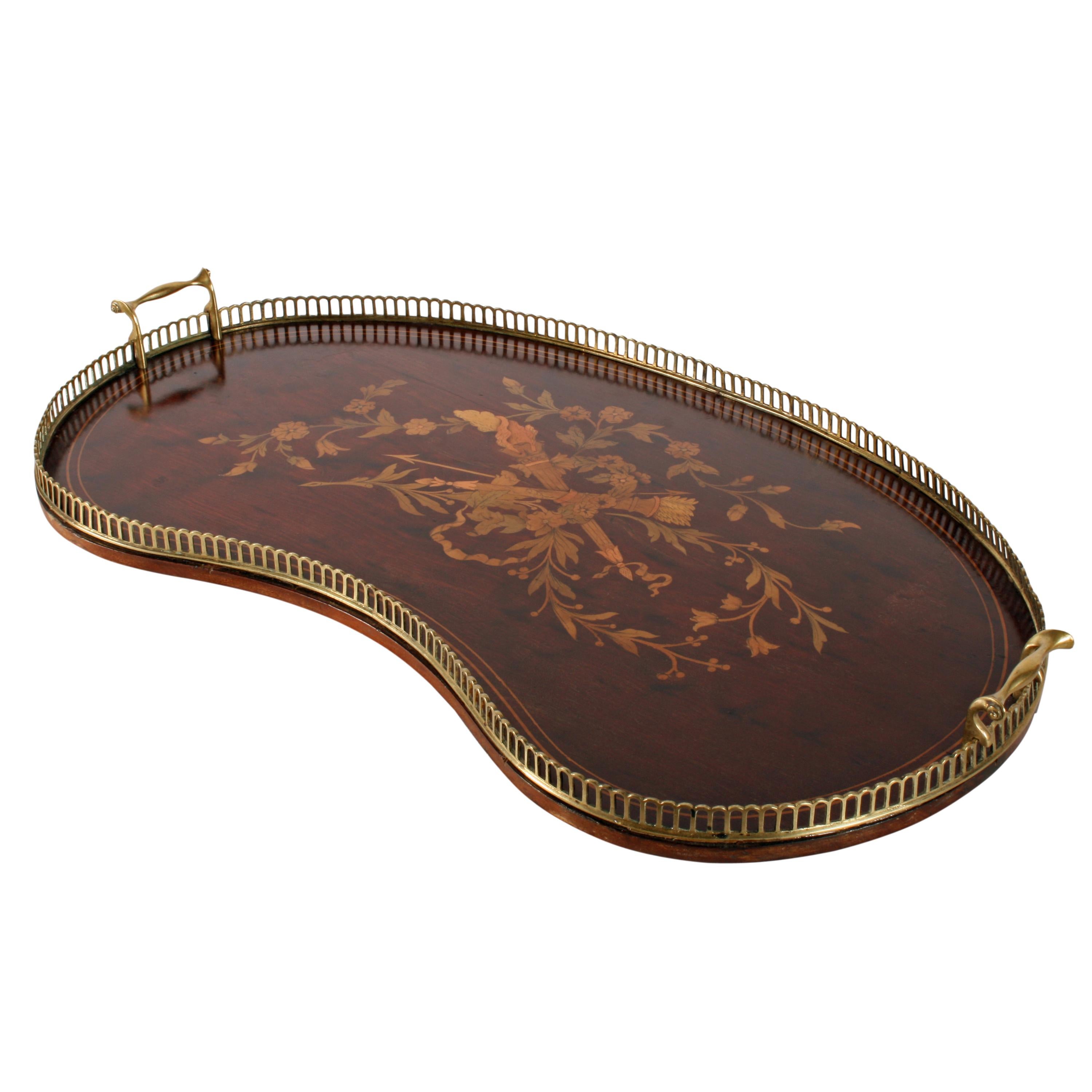 A late 19th century mahogany kidney shaped tray.

The tray is profusely marquetry inlaid in the centre and box wood line inlaid.

The tray has a pierced brass gallery to the edge with shaped brass carrying handles.

The tray is made from a