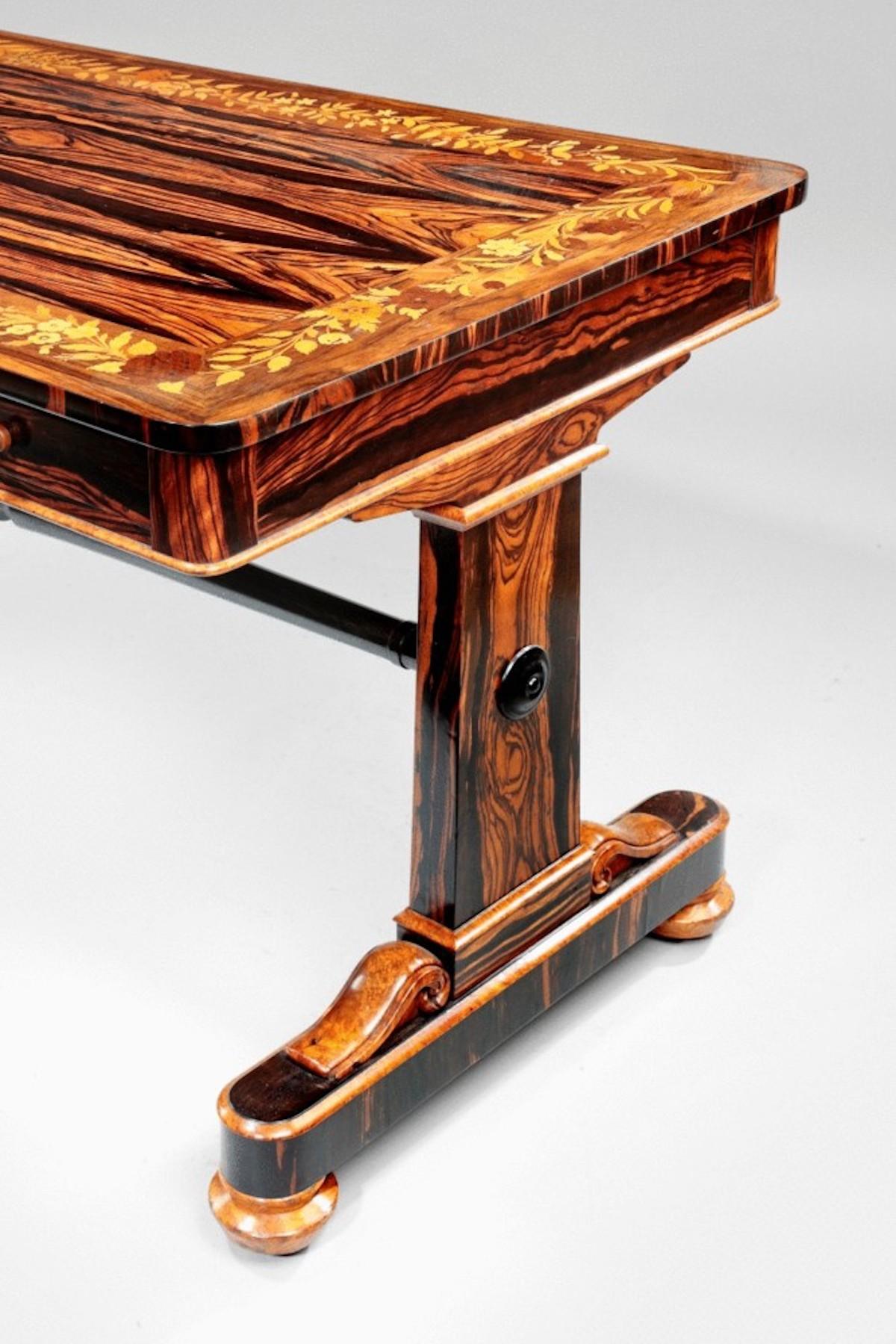 A rare late Regency marquetry library table inlaid with realistic depictions of flowers in a wide variety of exotic timbers, including coramandel, amboyna and walnut.