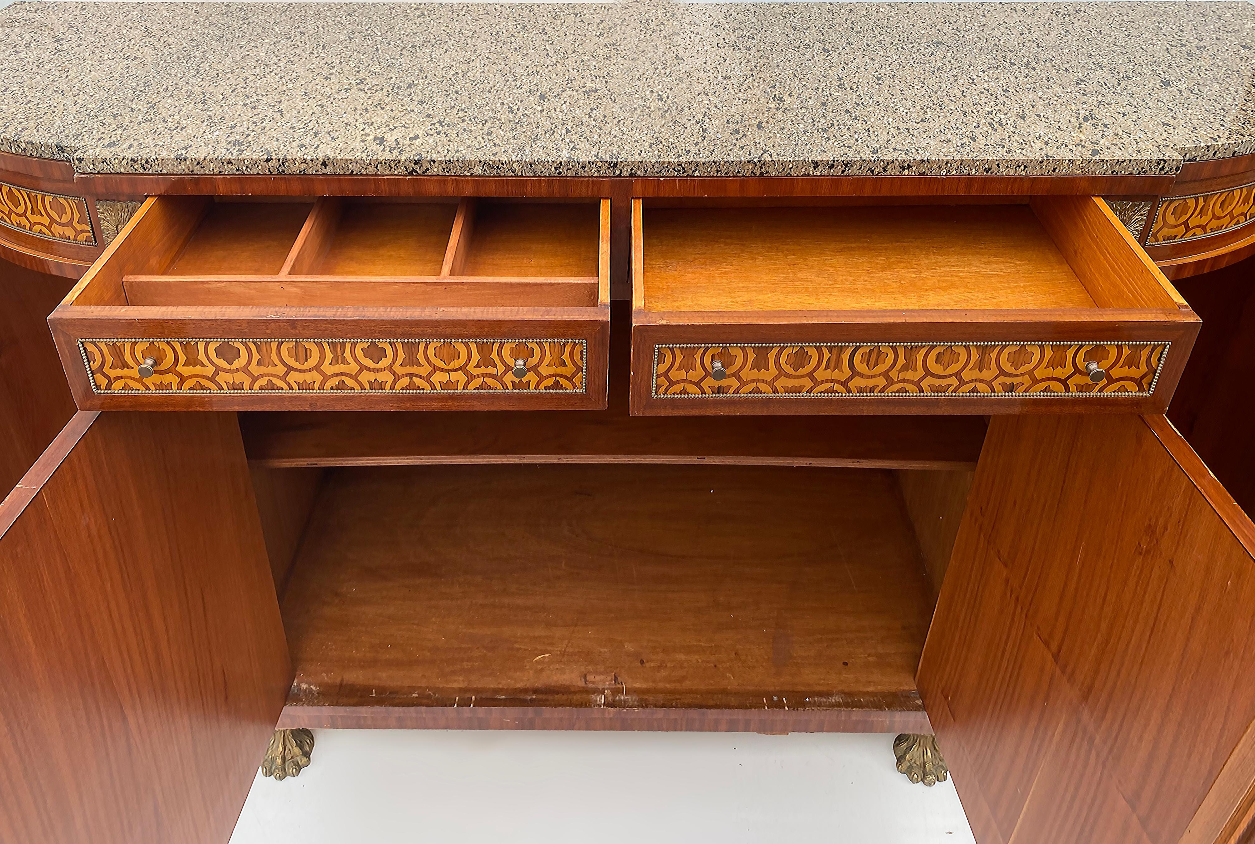 Marquetry Sideboard French, Granite, Inlay, Bronze Mounts and Feet

Offered for sale is a large 20th-century French design sideboard/credenza with marquetry inlays, gilt metal hardware, hairy claw feet, and a thick granite top.  This is an elegant