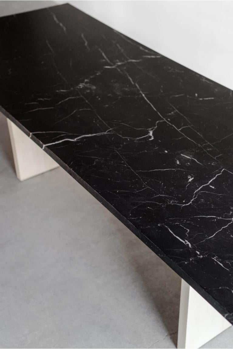 This dining table is custom made in Los Angeles. The solid wood boards are cut to size and joined. The stone is cut to size and honed.

Fissures, small cracks, areas of cloudiness and other organic characteristics occur naturally within marble.