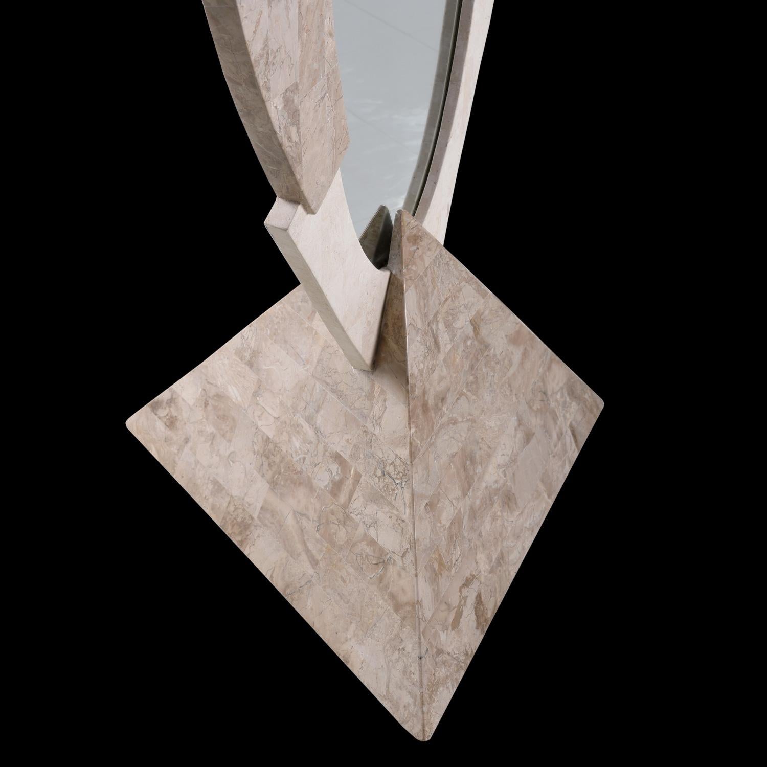 This pretty mirror is something fairy tales are made of. It boasts beautifully smooth and polished tessellated stone throughout and stands firmly on a stone carved pyramid. The multicolored stone and asymmetrical design give this piece a
