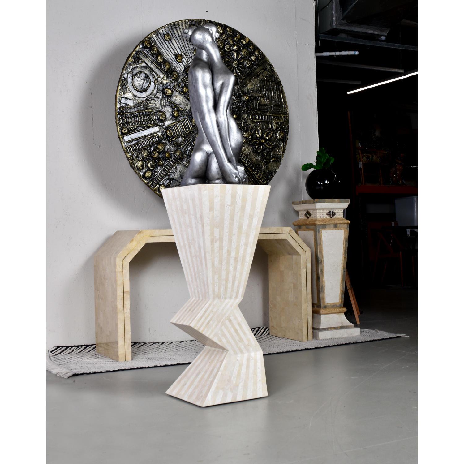 Stunning Nineteen-Laties (late 20th Century) Marquis Collection of Beverly Hills tessellated stone display pedestal. This pedestal is a work of art itself with a dynamic zig-zag asymmetric silhouette. The pedestal looks completely different