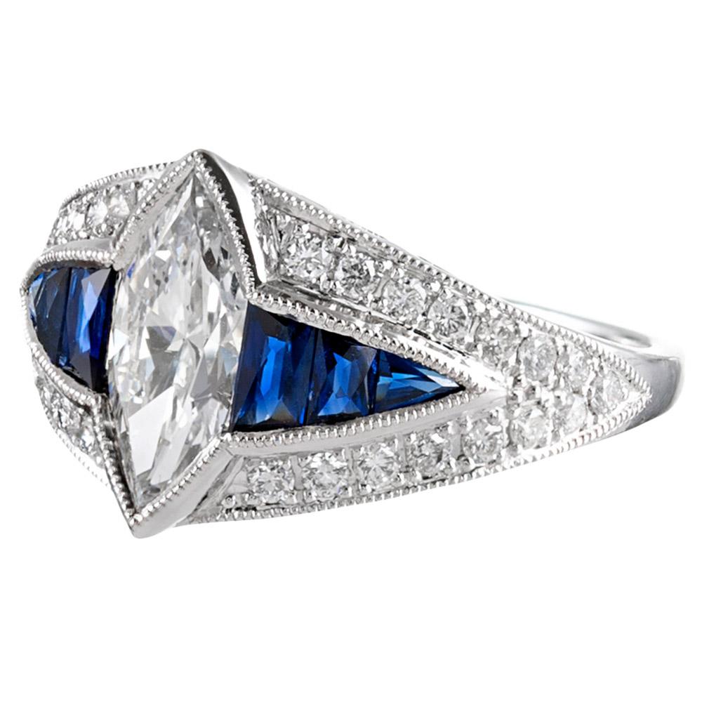 The design of this ring is inspired by the classic creations from the Art Deco period, yet the piece is of newer manufacture, offering superior physical integrity, yet a style that will be beloved for generations. The centerpiece is a 1.00 carat