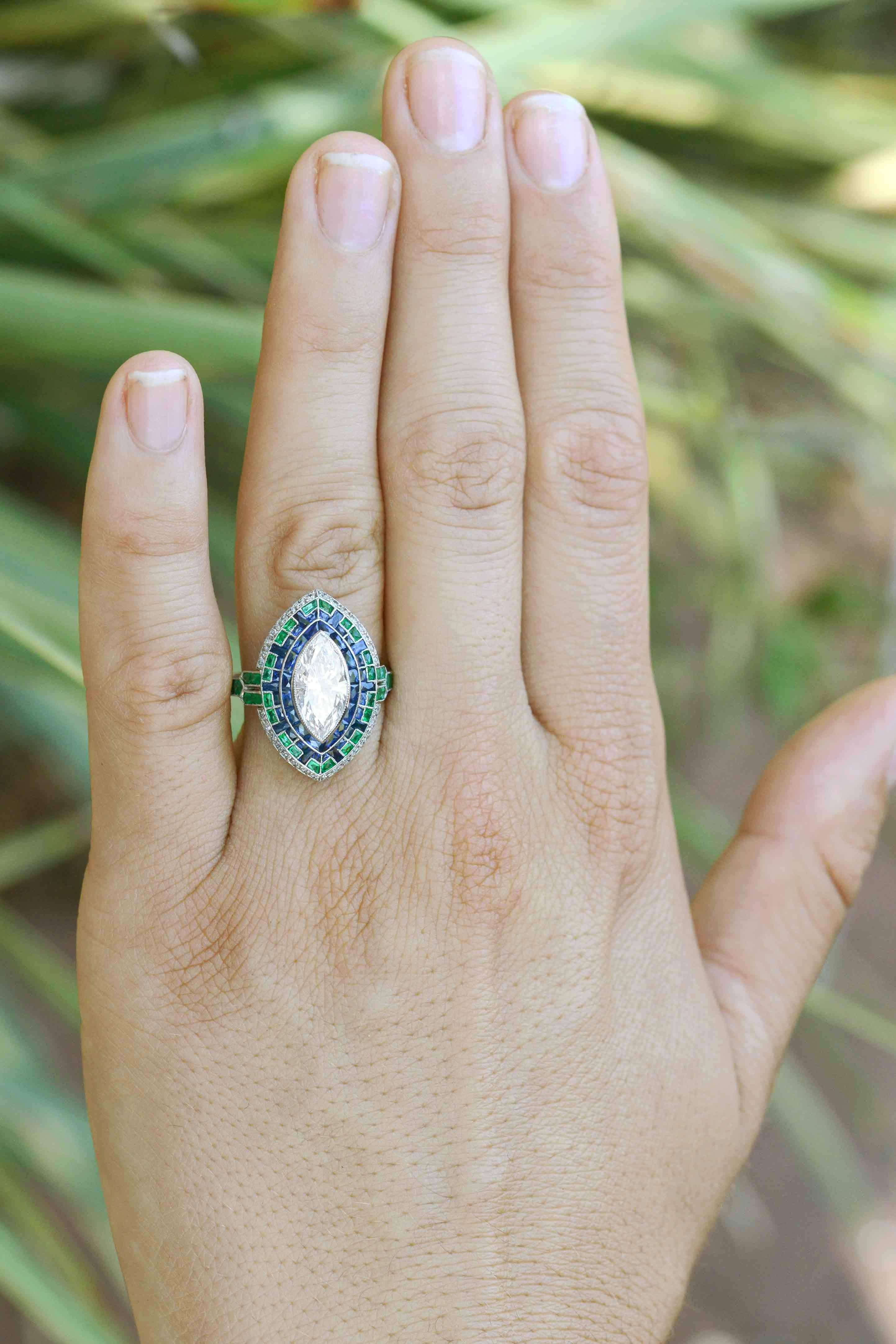 The Bel Air is a breathtakingly large 1.63 carat marquise diamond engagement ring with a detailed mosaic sapphire and emerald halo.  Some may argue that this Art Deco style masterpiece be worn as a cocktail ring. We won't argue!

Centered by a