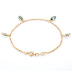 Marquise 2.54 Ct Blue Topaz Dangling Charm Bracelet Inlaid in 18K Yellow Gold