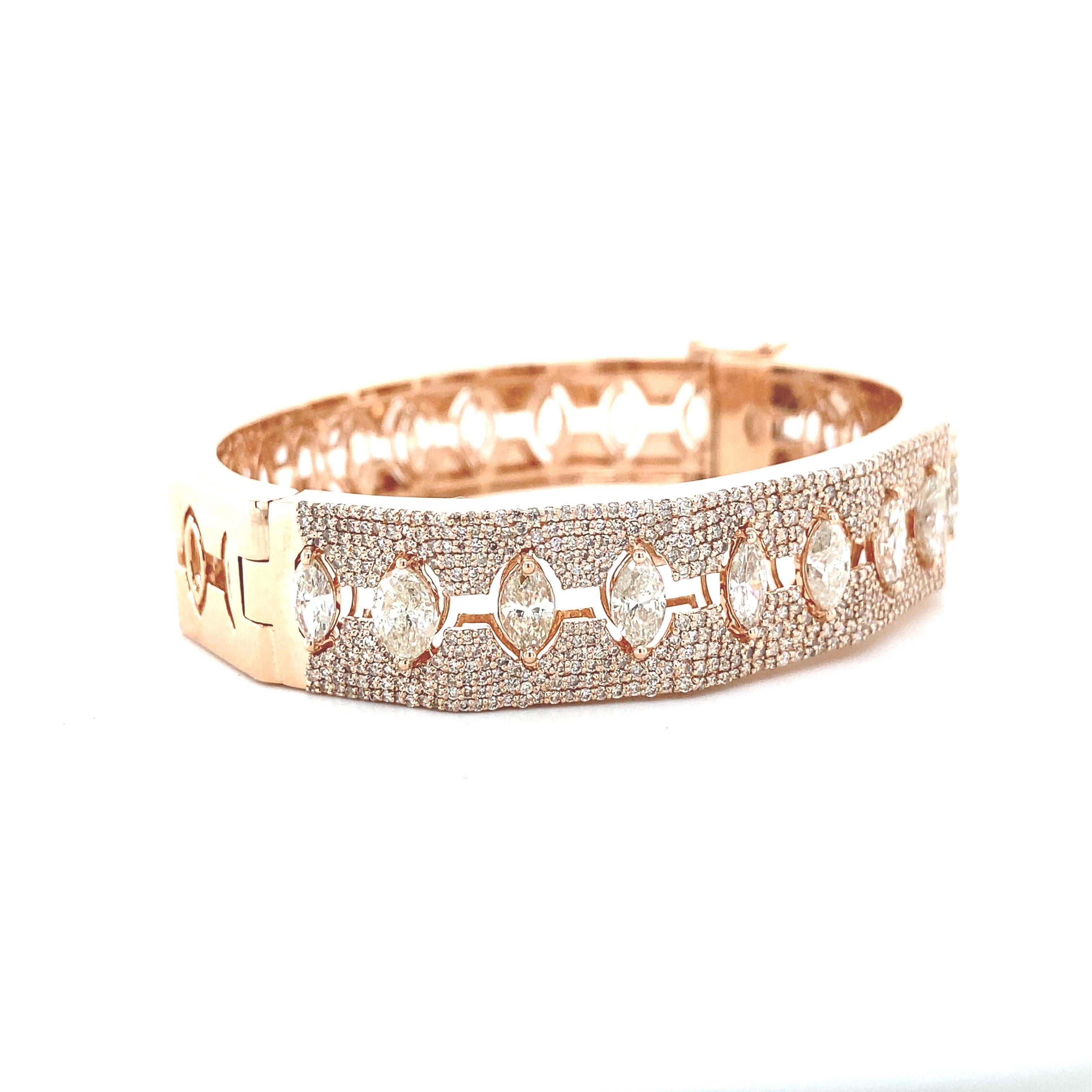 The bracelet is a stunning piece of craftsmanship, showcasing a brilliant array of marquise and round diamonds encased in the warm embrace of 18K rose gold. The delicate balance of diamond shapes creates an opulent tapestry of light and luxury,