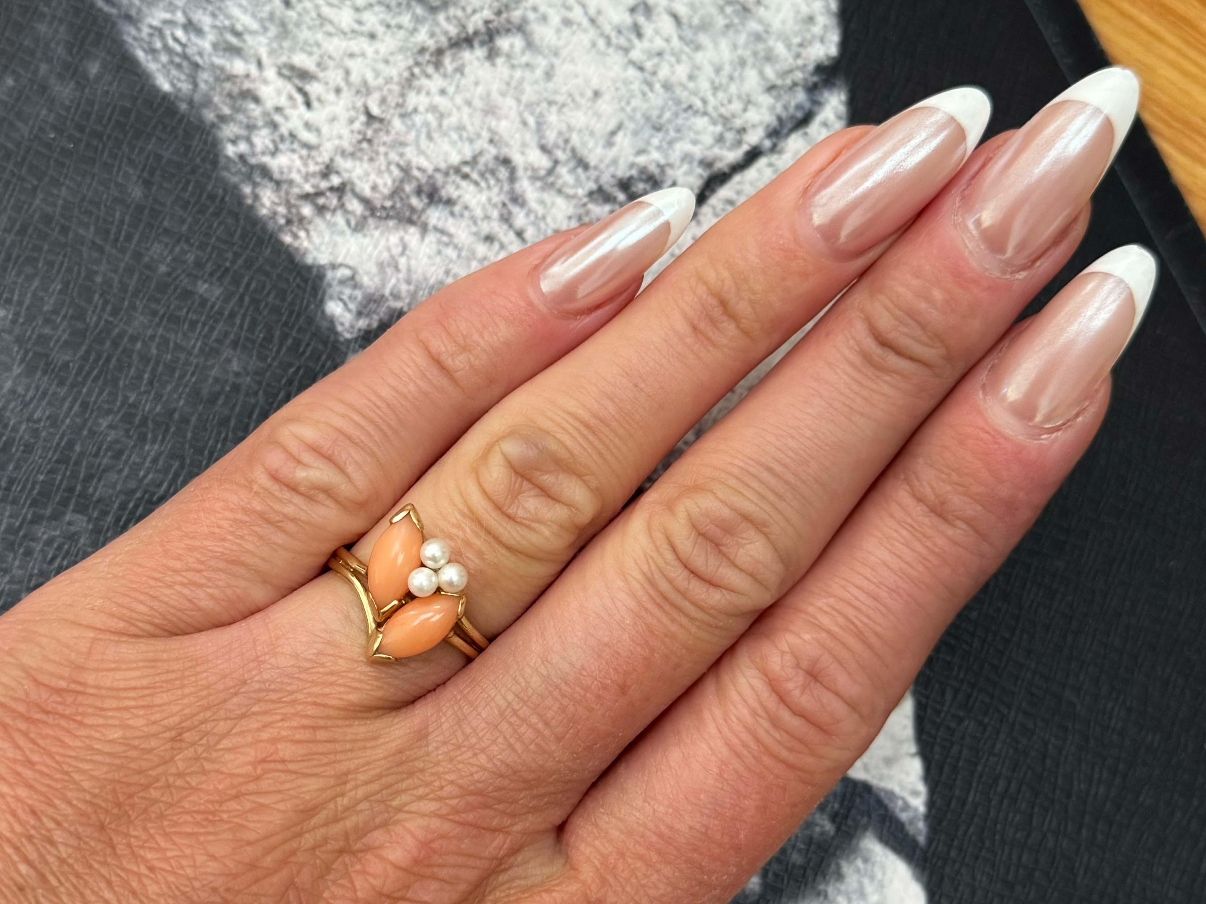 Item Specifications:

Metal: 14K Yellow Gold

Style: Statement Ring

Ring Size: 6.25 (resizing available for a fee)

Total Weight: 3.1 Grams

Gemstone: Angelskin Coral

Coral Measurements: ~11 mm x 5mm x 2.5 mm (per marquise)

Pearl Count: 3