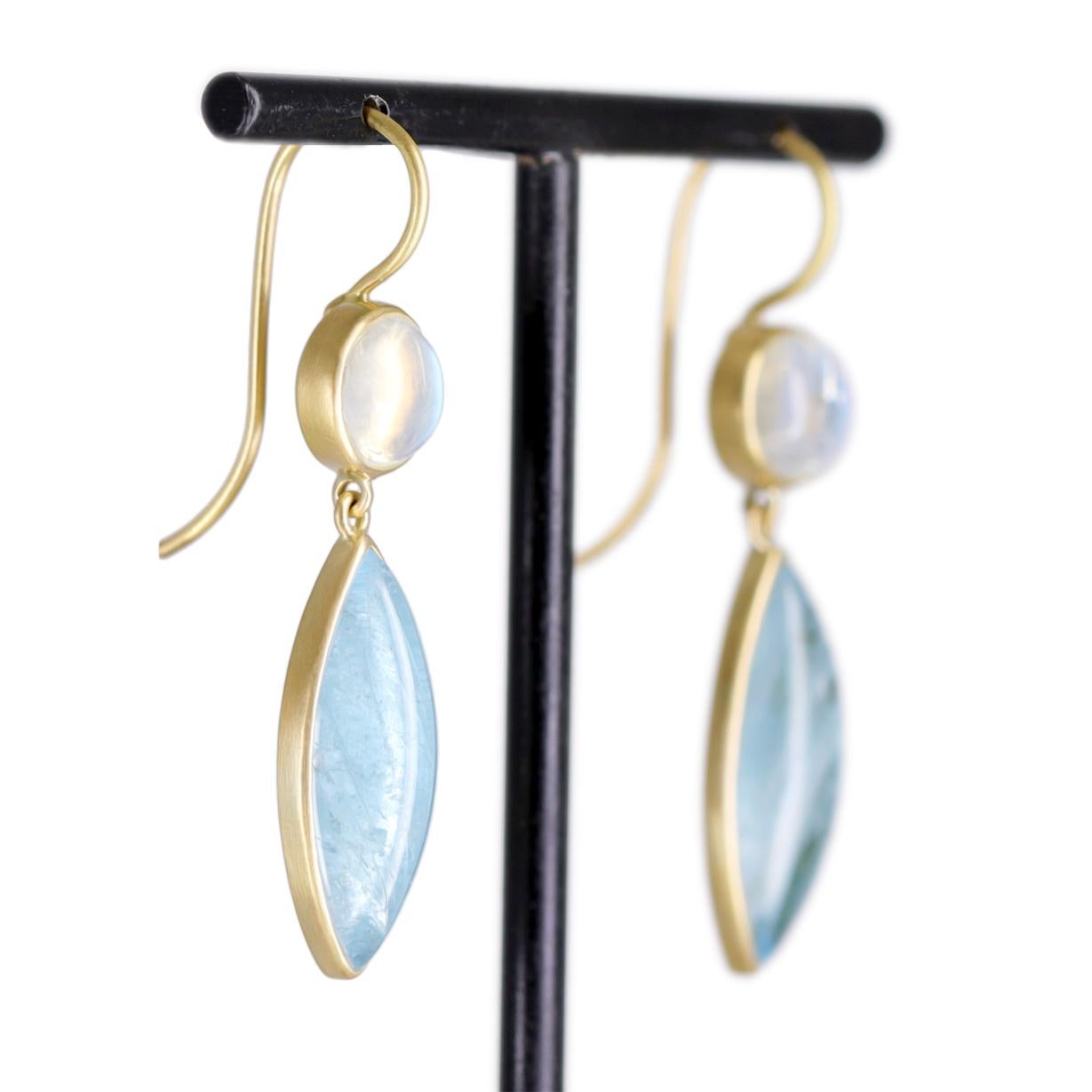 One of a Kind Drop Earrings by award-winning jewelry maker Lola Brooks, hand-fabricated in her signature-finished 18k yellow gold showcasing a gorgeous matched pair of shimmering marquise shaped aquamarine cabochons totaling 32.5 carats, bezel-set