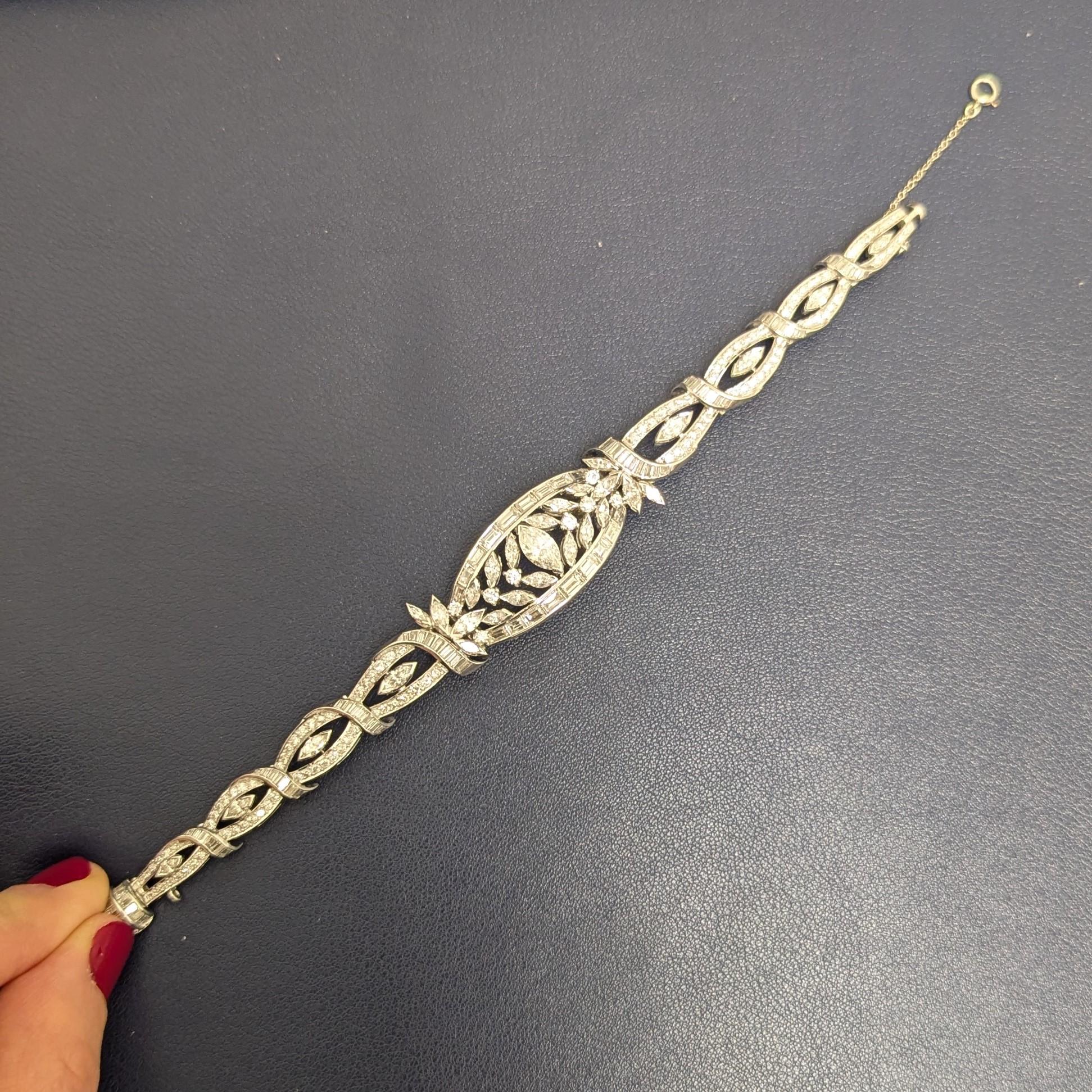This elegant diamond bracelet features an array of different shapes of diamonds. It is centered with one marquise diamond, weighing approximately 0.70 - 0.75 carats. That diamond is surrounded by 28 marquise diamonds, weighing approximately 2.25 -