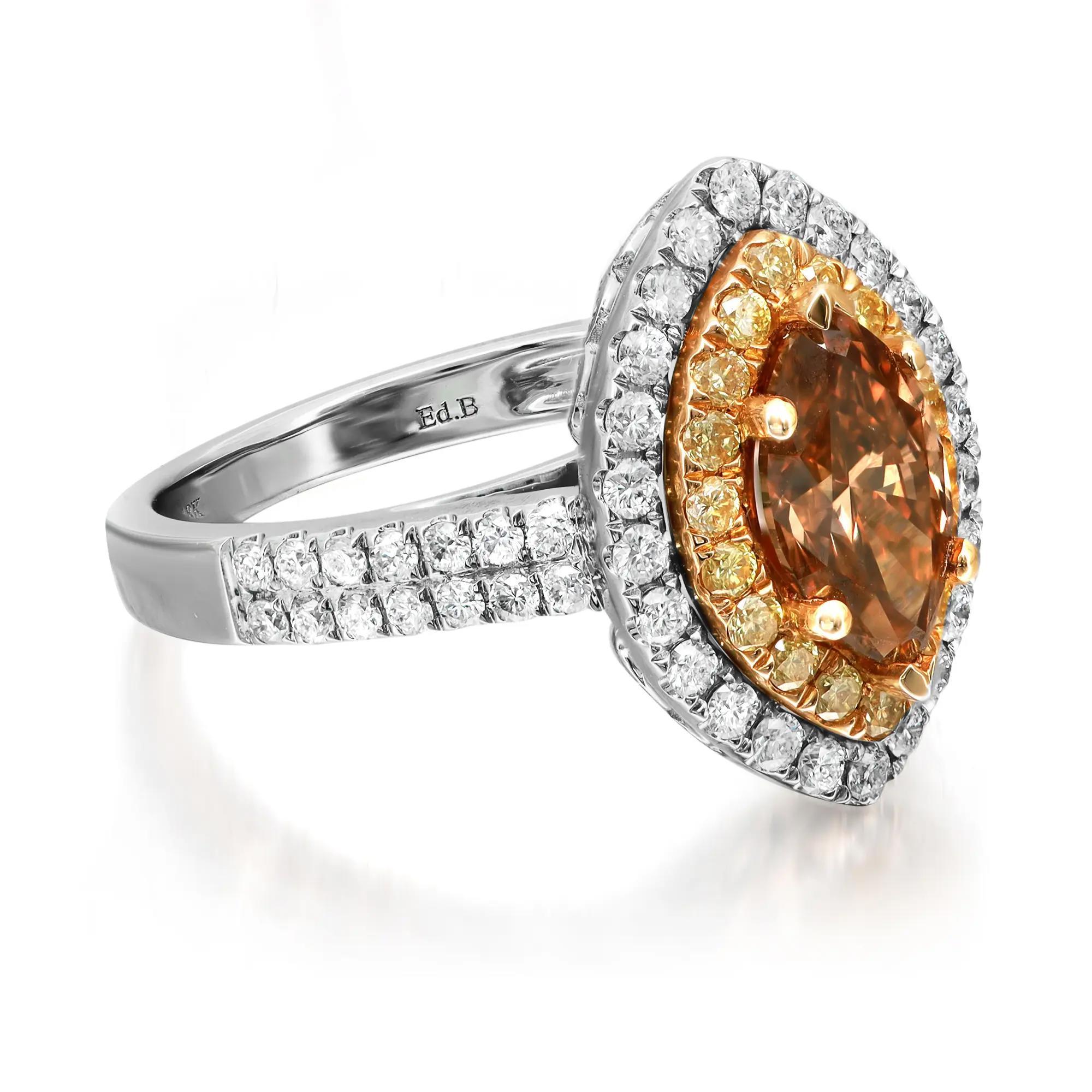 Magnificent ladies cocktail ring. This ring is centered by a beautiful prong set marquise shaped brown diamond. Accentuated with round cut yellow and white diamonds in a halo setting with round diamonds on band shoulders. Mounted in fine 18k white