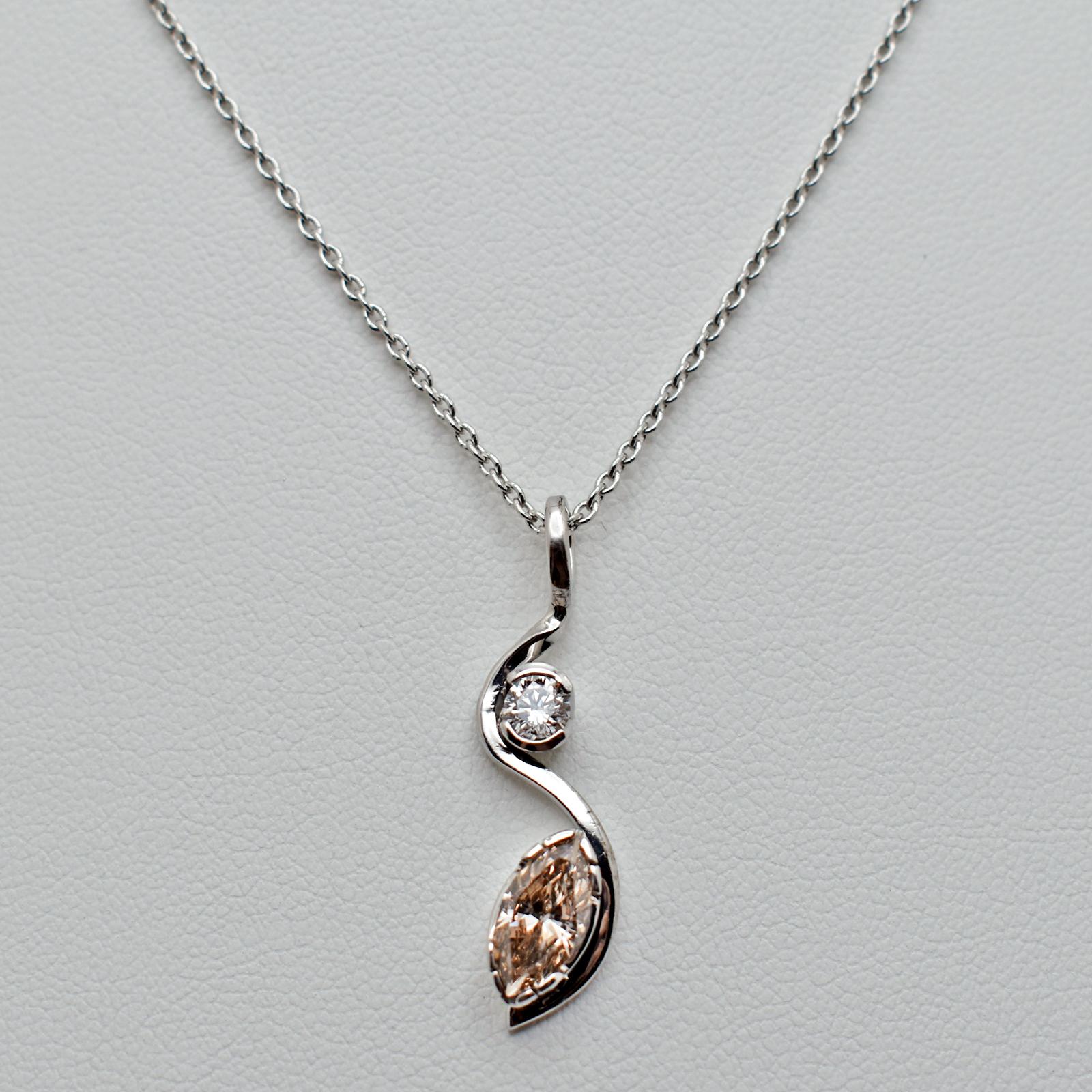 Two-Stone marquise Champagne Diamond and round-cut white Diamond 14k white gold pendant with a modern, sleek design on a cable chain necklace. This pendant necklace is in excellent condition, ready to be worn and cherished.

Key Features:

•