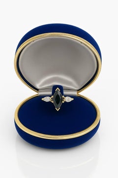 marquise-cut black sapphire and two marquise-cut white diamonds set in yellow go