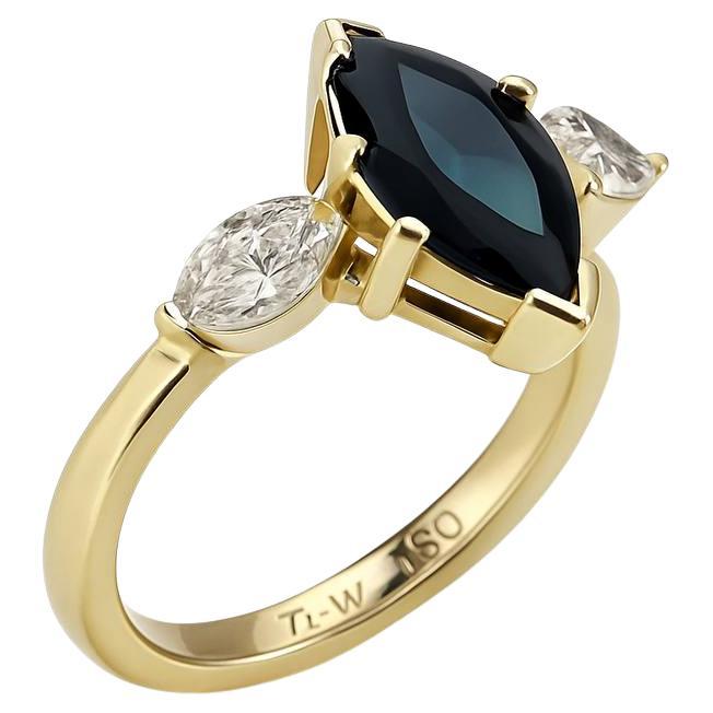 marquise-cut black sapphire and two marquise-cut white diamonds set in yellow go