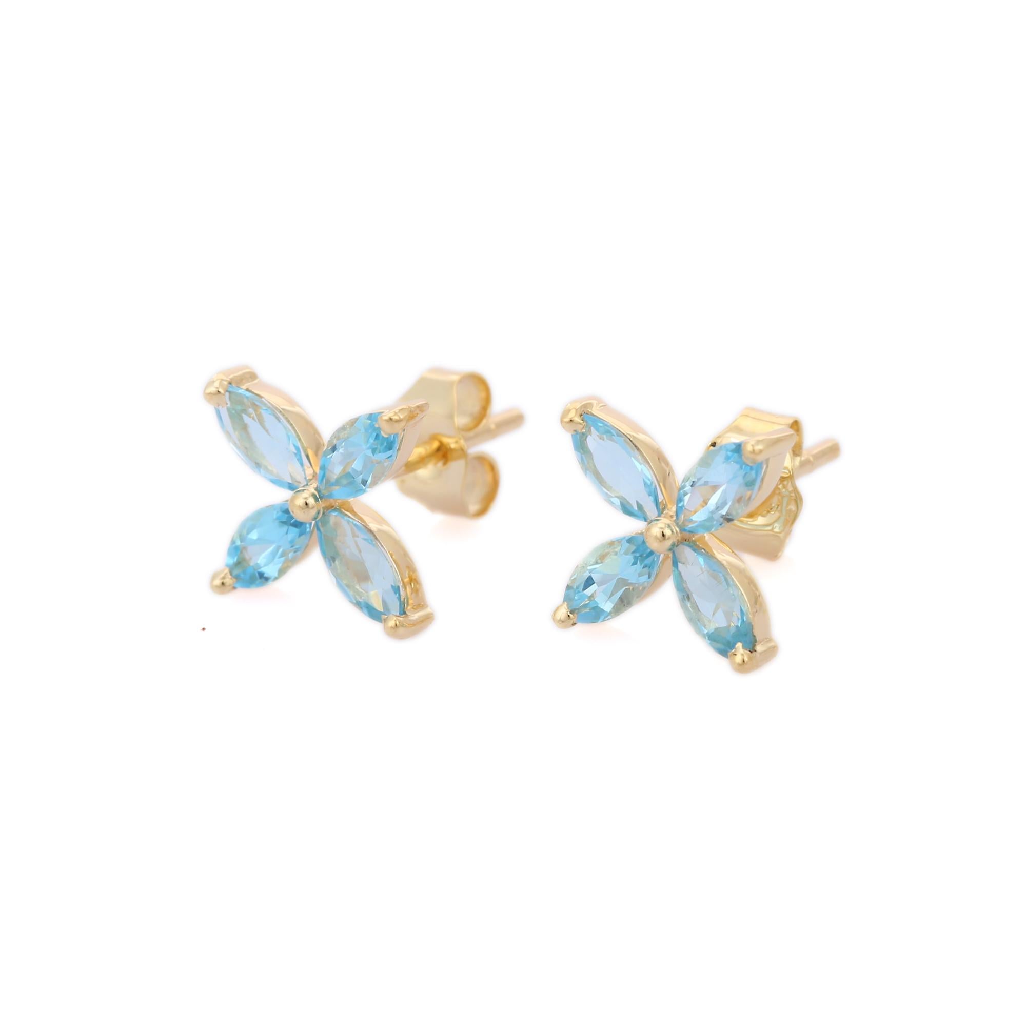 Blauer Topas Blume Pushback Ohrstecker in 14K Gold, um ein Statement mit Ihrem Look zu machen. Sie brauchen Ohrstecker, um mit Ihrem Look ein Statement zu setzen. Diese Ohrringe verleihen dem blauen Topas im Marquiseschliff einen funkelnden,