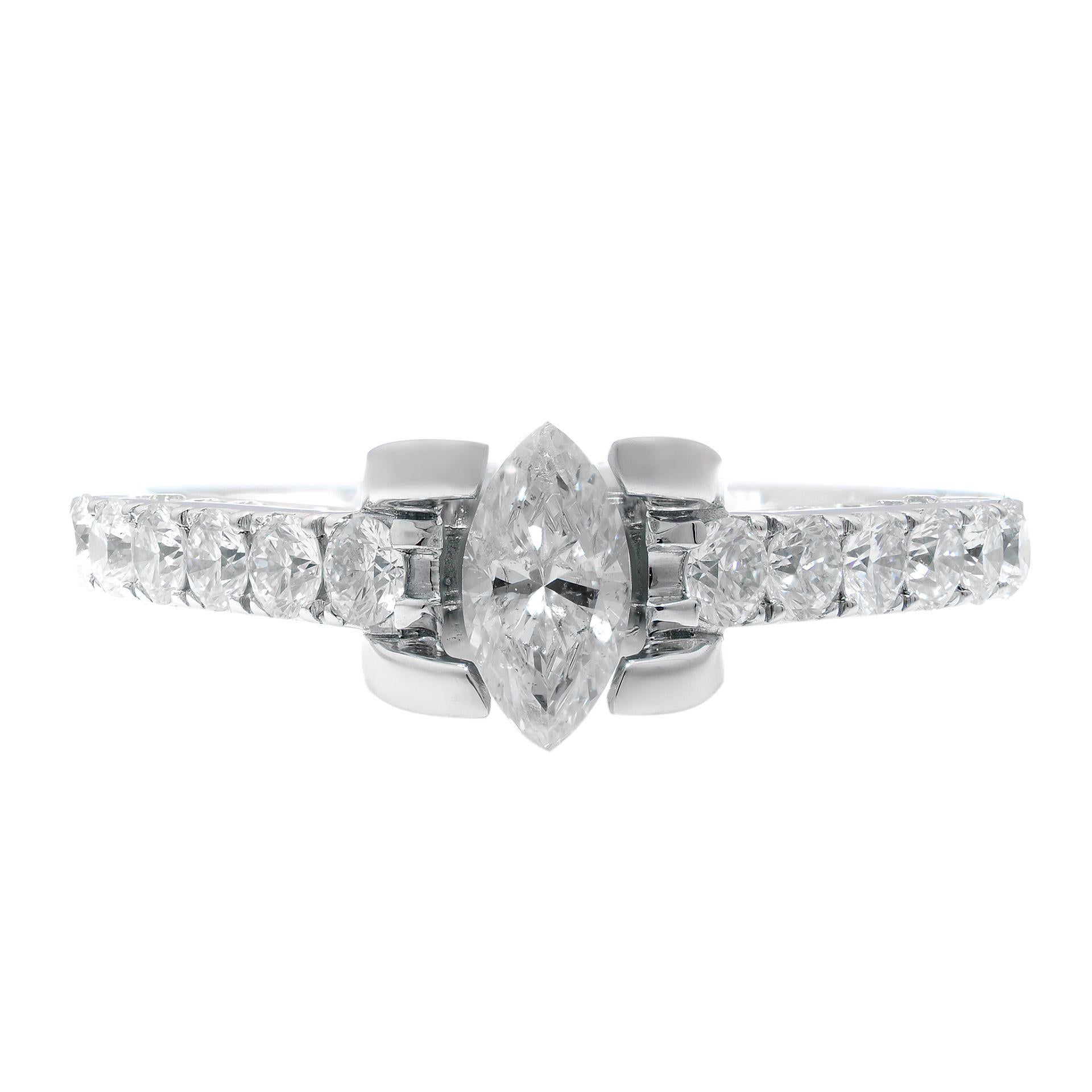 This beautiful diamond engagement ring is crafted in 14K white gold. Featuring a marquise cut center diamond with round brilliant cut diamond accents. Total diamond weight: 1.05cts. Ring size 7. Total weight: 4 gms. Comes with a presentable gift