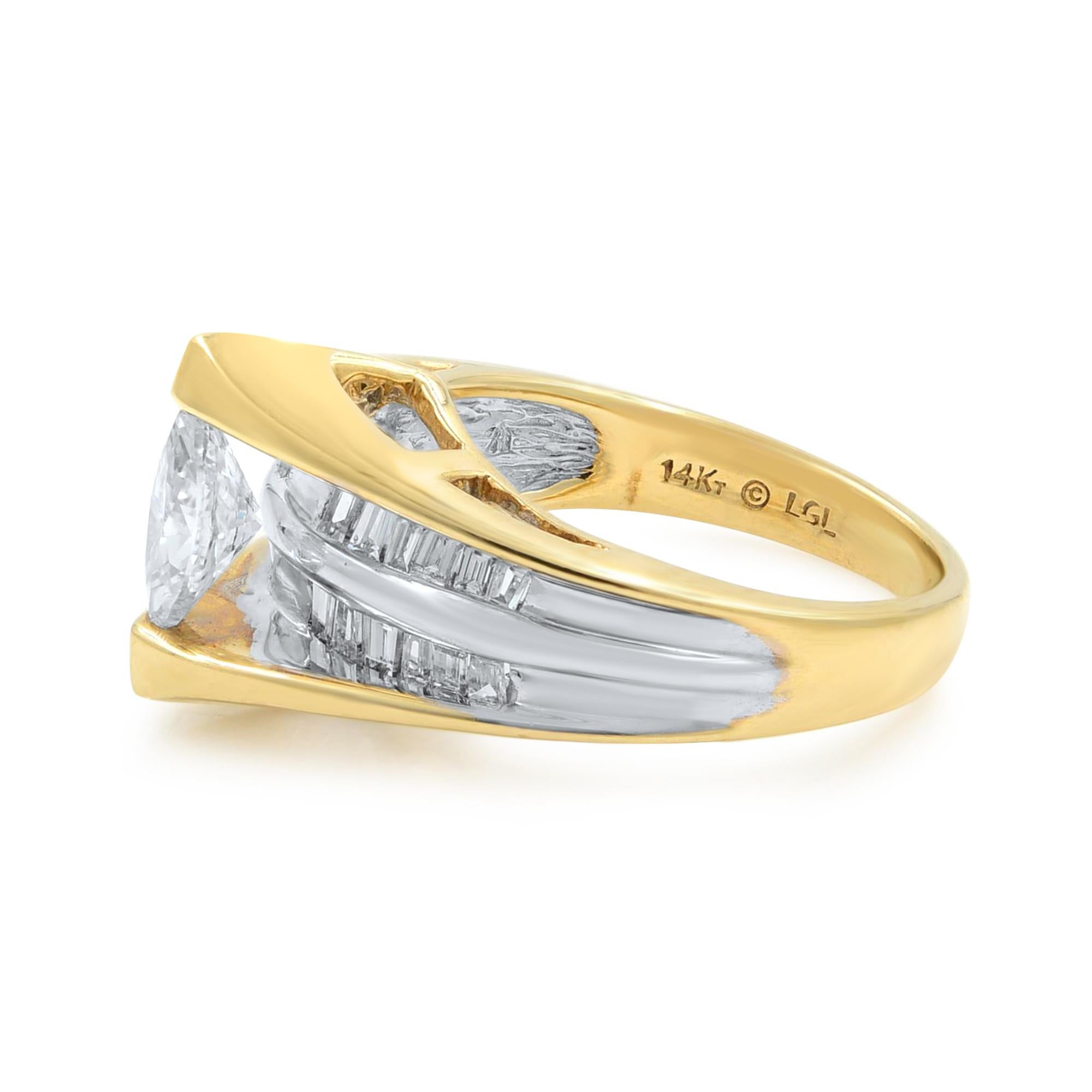This beautiful two tone ring features a marquise cut center diamond weighing 0.82ct. The ring is accented with two lines of baguette cut diamonds behind the main stone, separated with a line of white gold. It is crafted in 14k yellow and white gold.