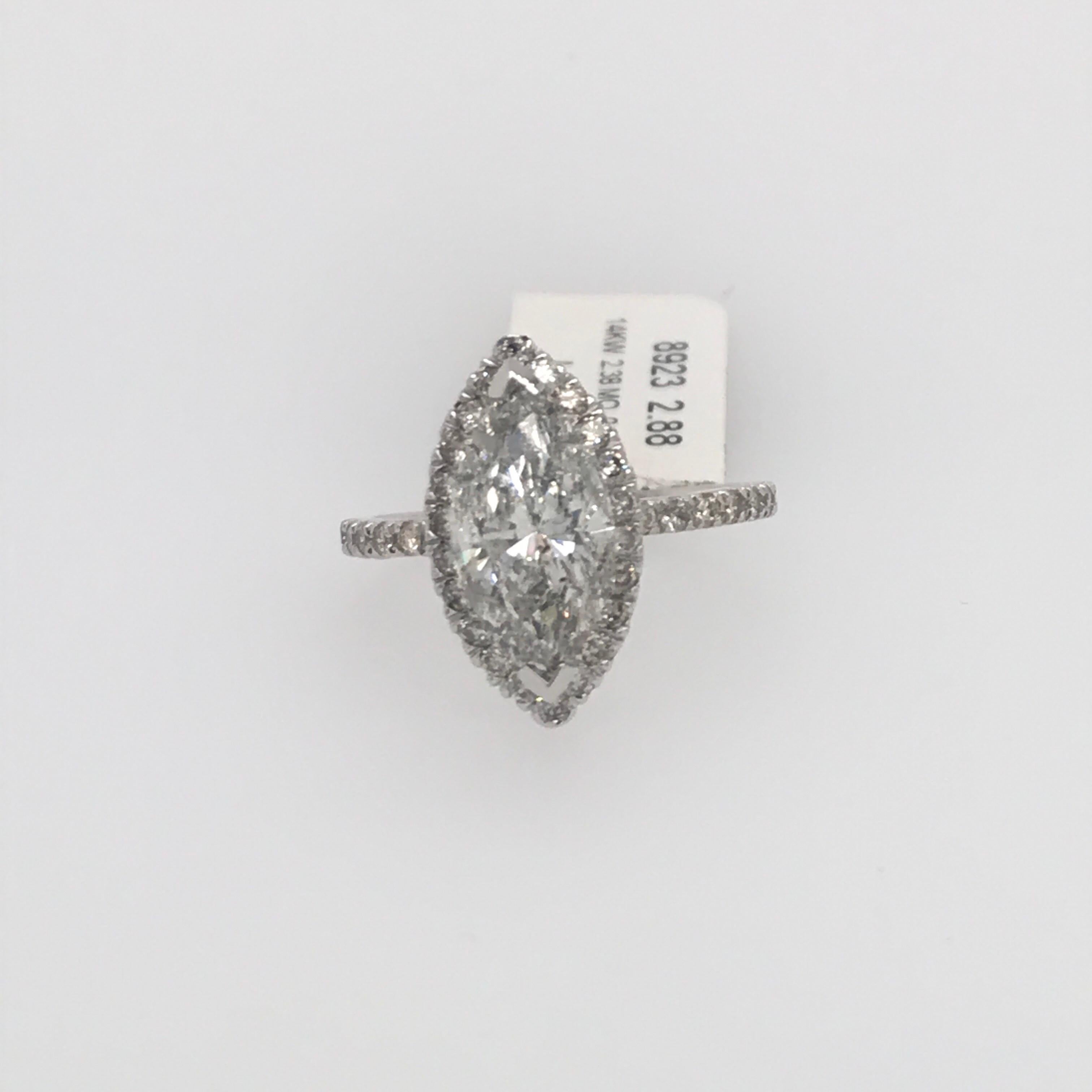 14K White Gold engagement ring featuring one marquise cut diamond weighing 2.38 carats flanked with a diamond halo weighing 0.50 carats. 
Color J-K
Clarity I1-I2