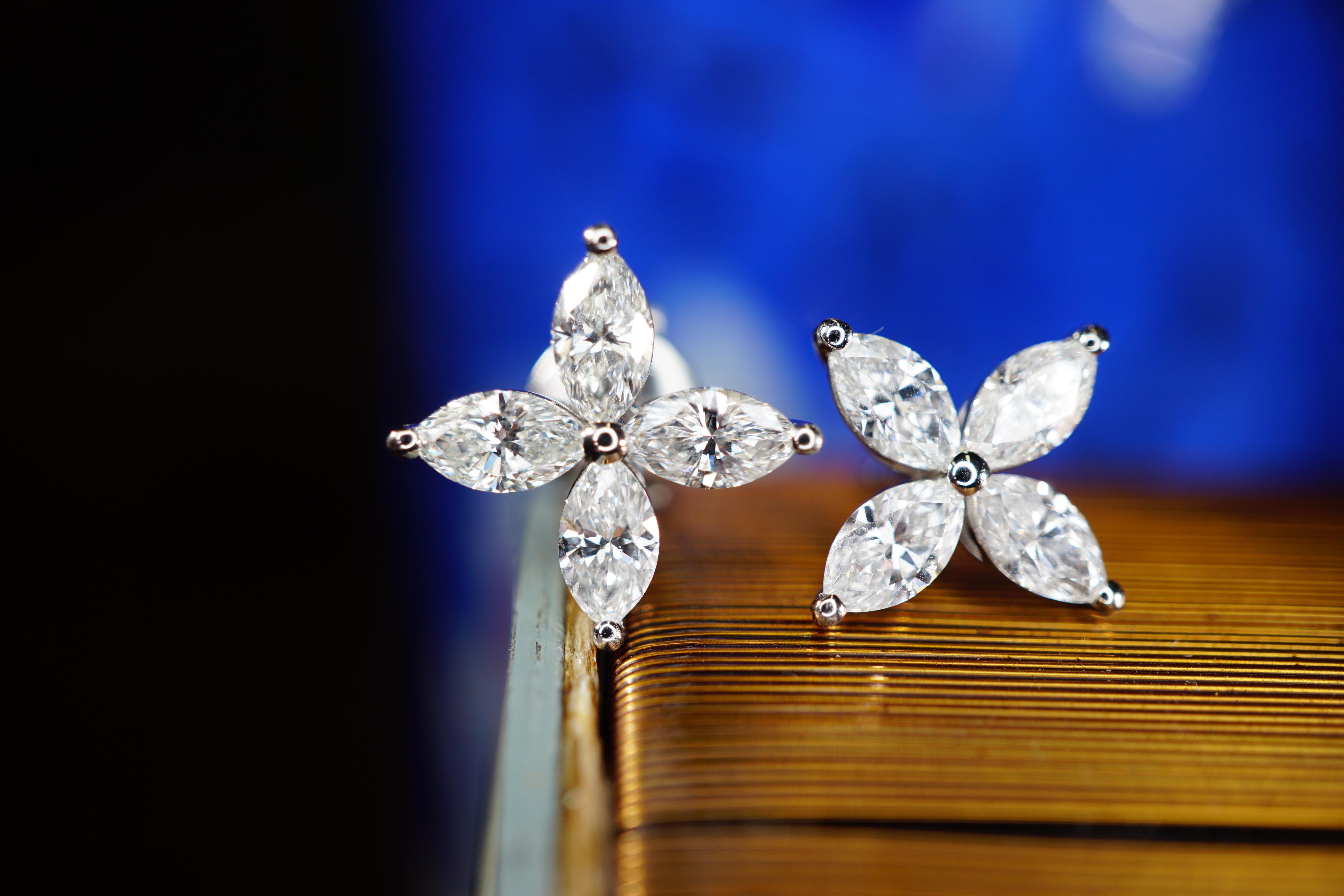 Pair of earrings featuring four marquise cut diamonds set in platinum to create a shinning floral design. All four marquise's DEF VVS2-VS2 total 1.64 carats. Total weight of the earrings is 3.42 grams. Proudly crafted by SIMON ARDEM artisans in New