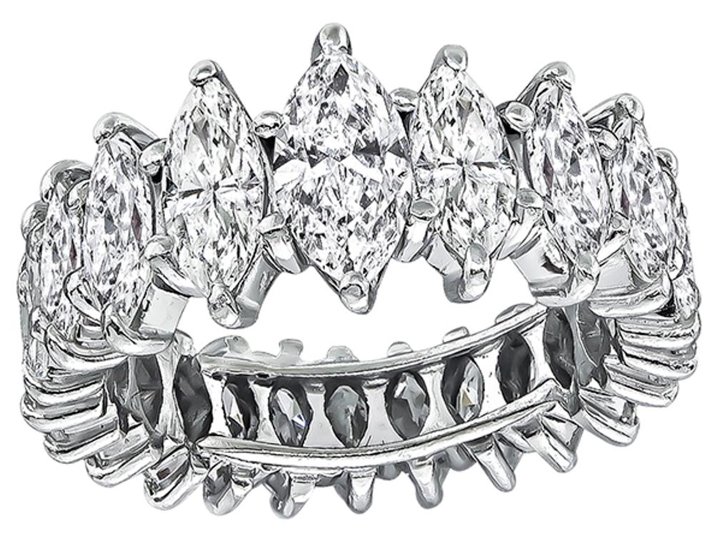 This elegant platinum eternity wedding band from the 1950s is set with sparkling marquise cut diamonds that weigh approximately 3.75ct. graded H-I color with VS1-SI1 clarity. The band has a tapering width from 7mm to 10mm. 
The band is size