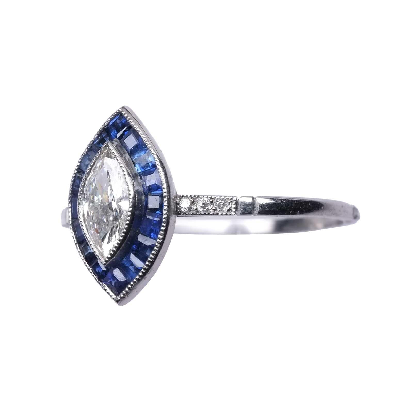 Ring set in platinum with marquise cut diamond of good commercial white, VVS for circa 0,34 ct surrounded by calibrated cut natural sapphires and small diamonds embellishing the ring shank.

Highlights
- Marquise cut diamond 0,34 ct circa
-