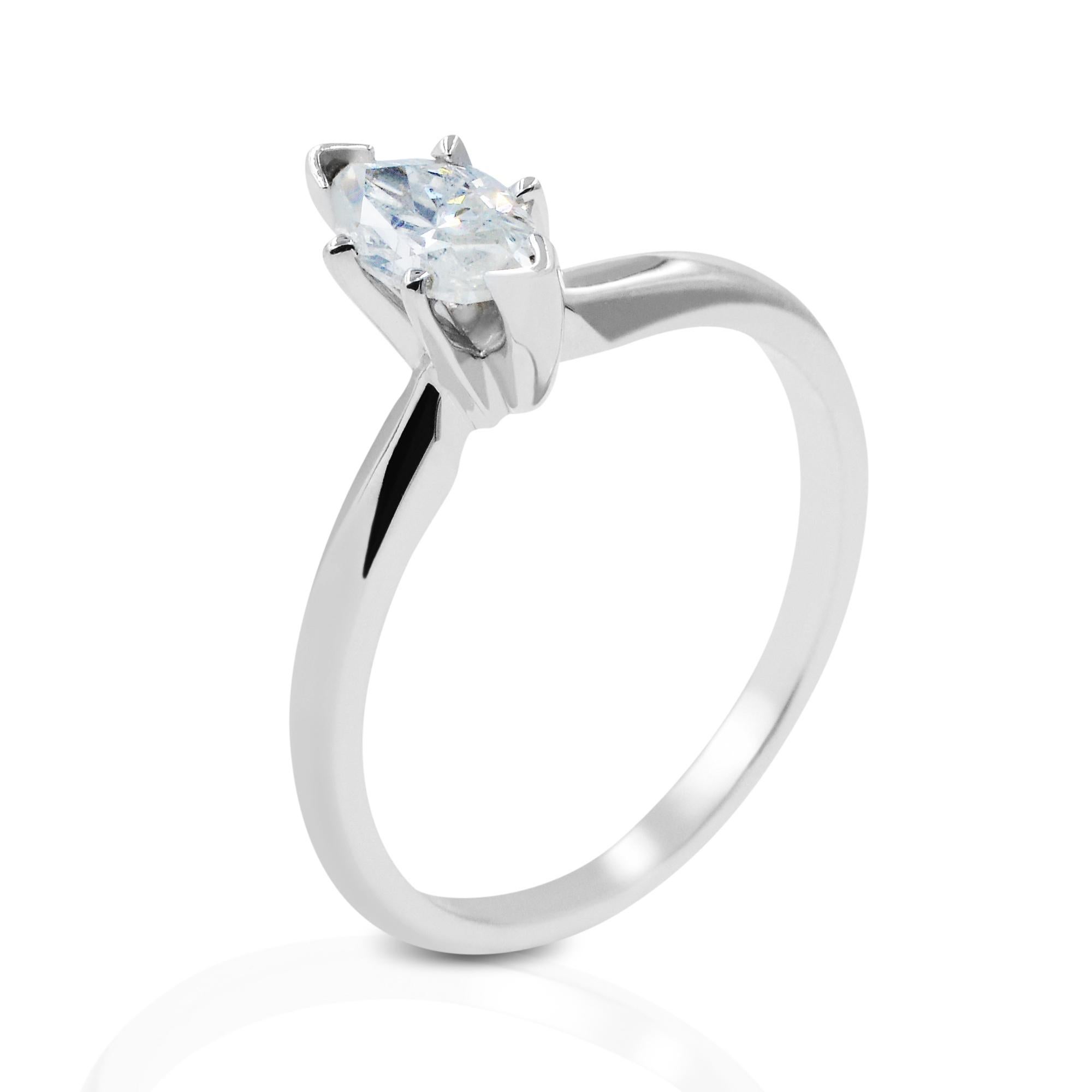 This simple and stunning solitaire engagement ring features a prong set marquise cut diamond weighing 0.62ct, encrusted in 14k white gold. The white gold is rhodium finished giving this design the look of platinum. Diamond quality: G-H color and