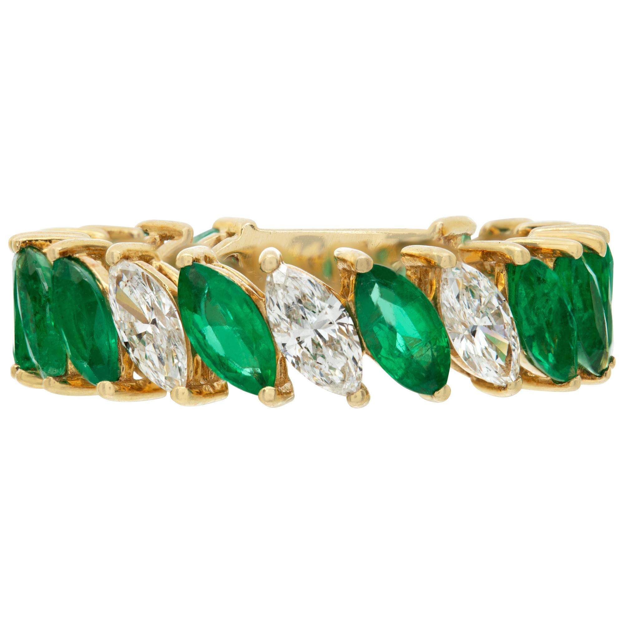 Marquise cut Emerald & Diamond Eternity ring in 18K yellow gold. Total emerald/diamonds weight: 3.90 carats (Stamped inside the ring with hallmarks 55292). Width: 5mm. Size 7This Diamond/Emerald ring is currently size 7 and some items can be sized