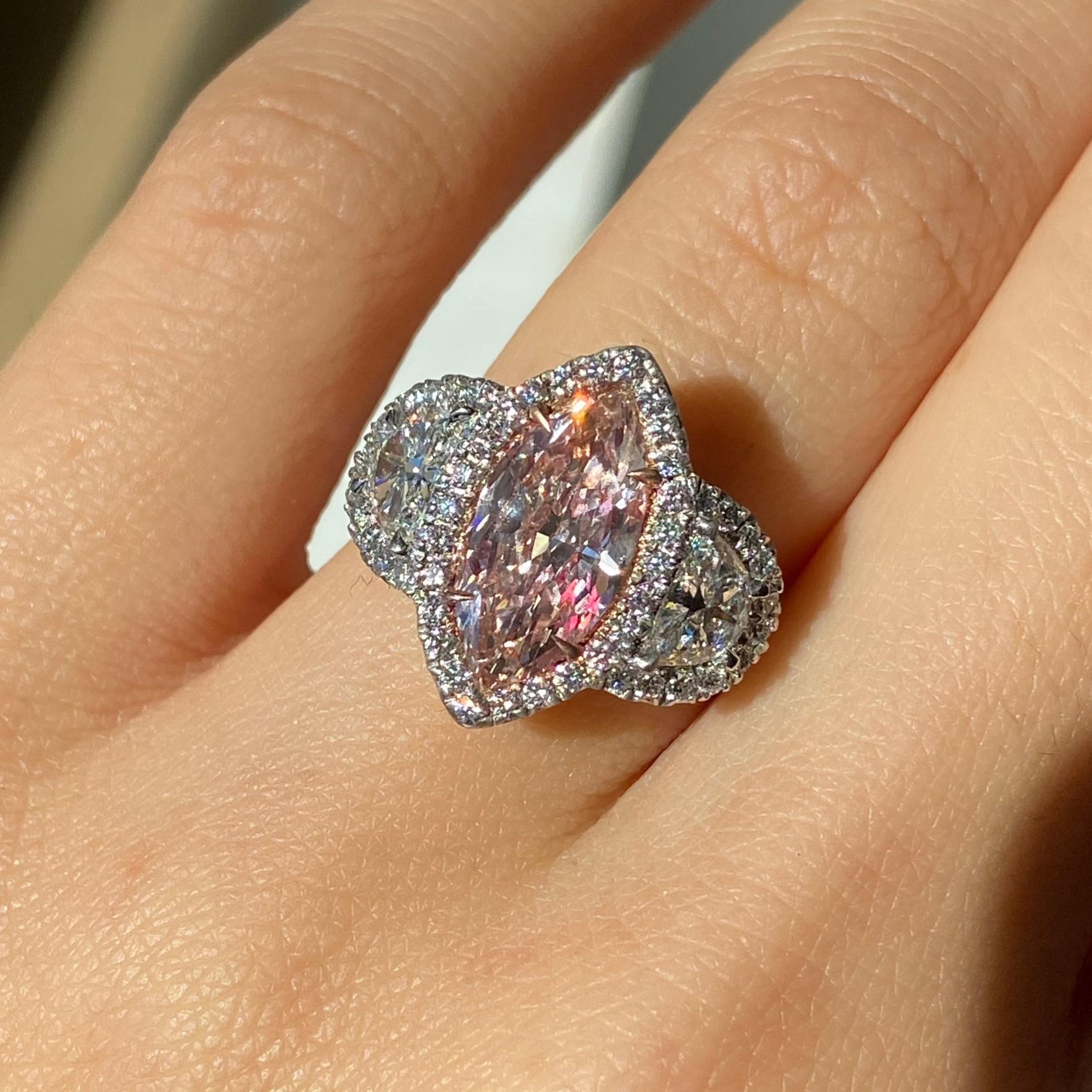 This exquisite pink diamond engagement ring features a striking 2.03-carat fancy pink-brown marquise cut diamond at its heart, offering a unique blend of romance and elegance. With SI2 clarity, this GIA certified diamond shines with character and