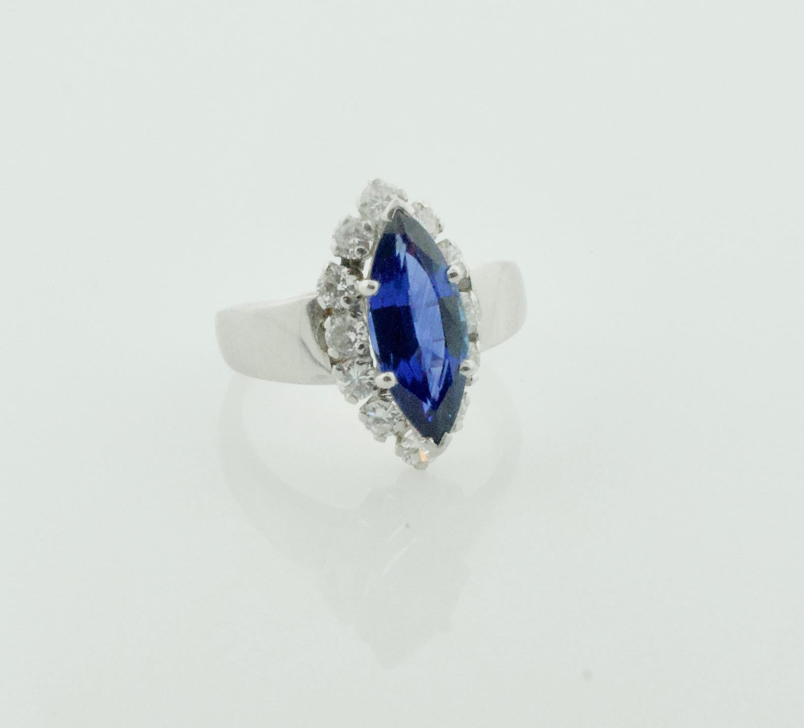 Marquise Cut Sapphire and Diamond Ring in Platinum Circa 1960's
One Marquise Cut Sapphire Weighing 3.20 Carats Approximately [bright with no imperfections visible to the naked eye]
Twelve Round Brilliant Cut Diamonds Weighing 1.00 Carats