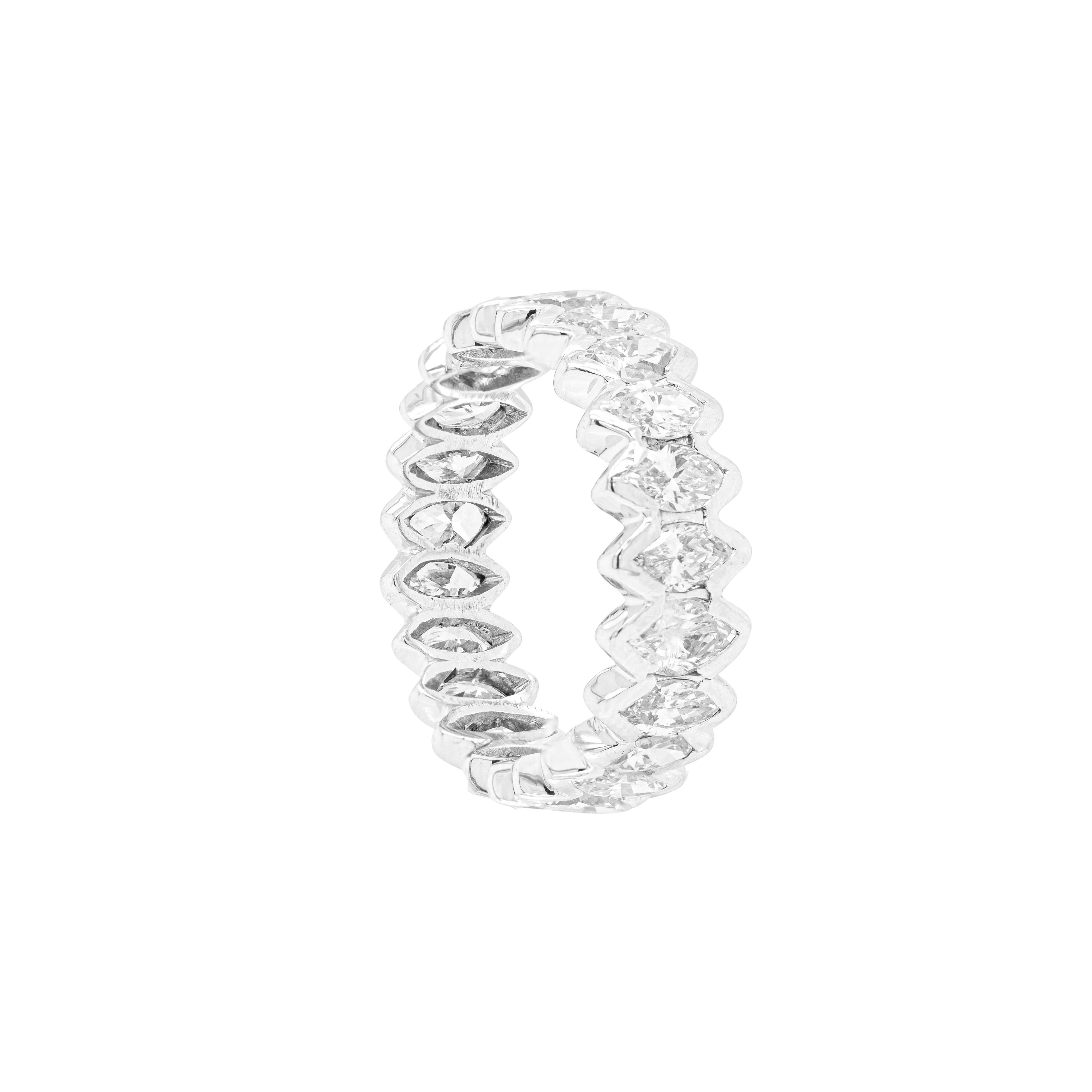 This handmade eternity ring features 22 marquise shaped diamonds set in rub-over, open back settings, with a total approximate weight of 2.50ct, all mounted in 18 carat white gold. The ring weighs 5.7 grams and measures 7.2mm in width. UK finger