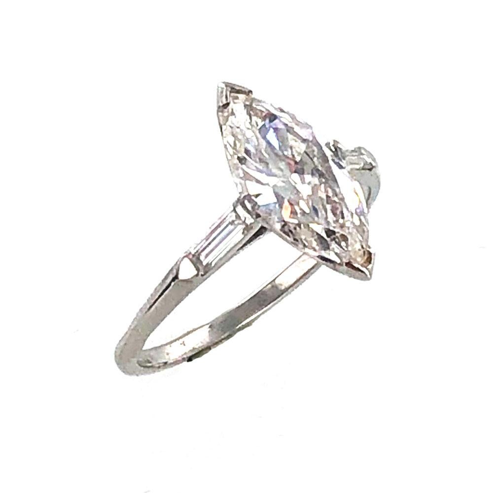 This vibrant marquise diamond engagement ring features a 2.29 carat marquise cut diamond that has been graded by the GIA. The diamond is graded J color and VS1 clarity, and is set in an 18 karat white gold mounting with two baguette cut diamonds