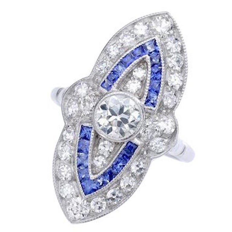 Marquise Diamond and Calibrated Sapphire Platinum Ring For Sale