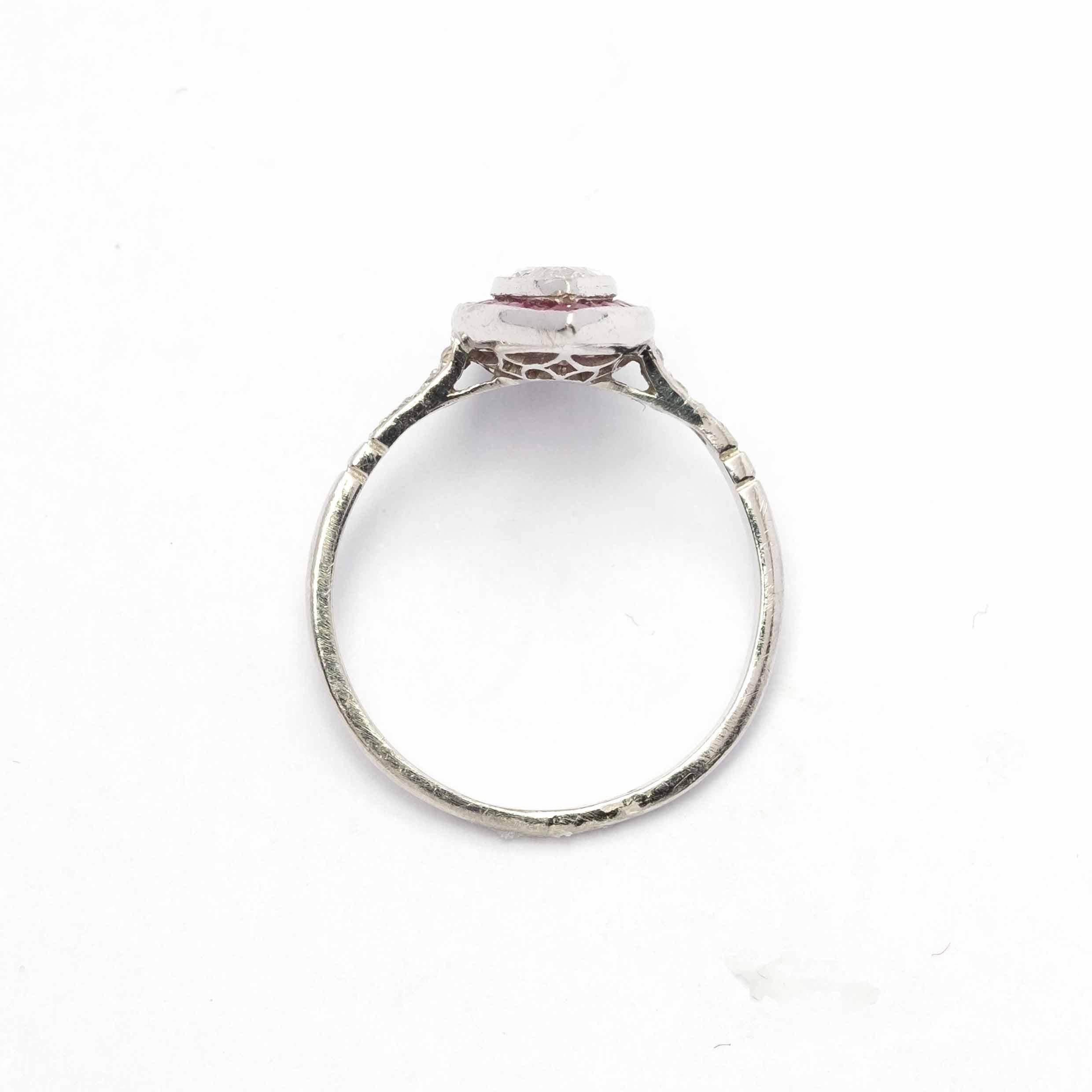 Elegant vintage ring set in platinum with marquise cut diamond of 0.50 ct c.a. of good commercial white. Surrounded by calibrated cut natural rubies.

Highlights:
- Platinum setting
- Marquise cut diamond 0.50ct c.a. VS (very small inclusions)
-