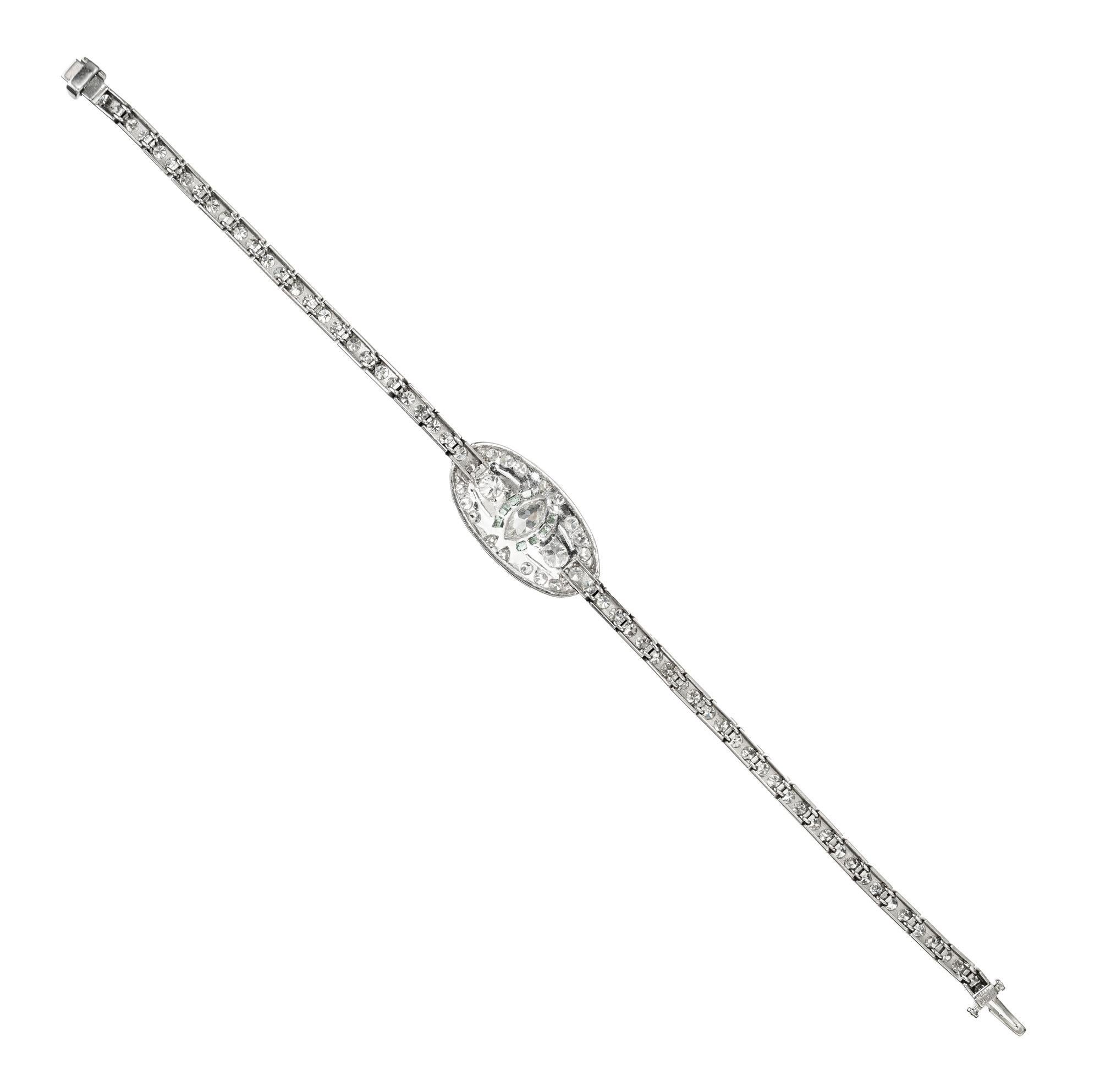 Beautiful vintage 1940s platinum bracelet set with a .35 carat marquise center diamond flanked by 8 calibre cut emeralds and 80 round diamonds with at total weight of 4.00cts. The length being 7.25 inches. The decorative centerpiece is attached to a