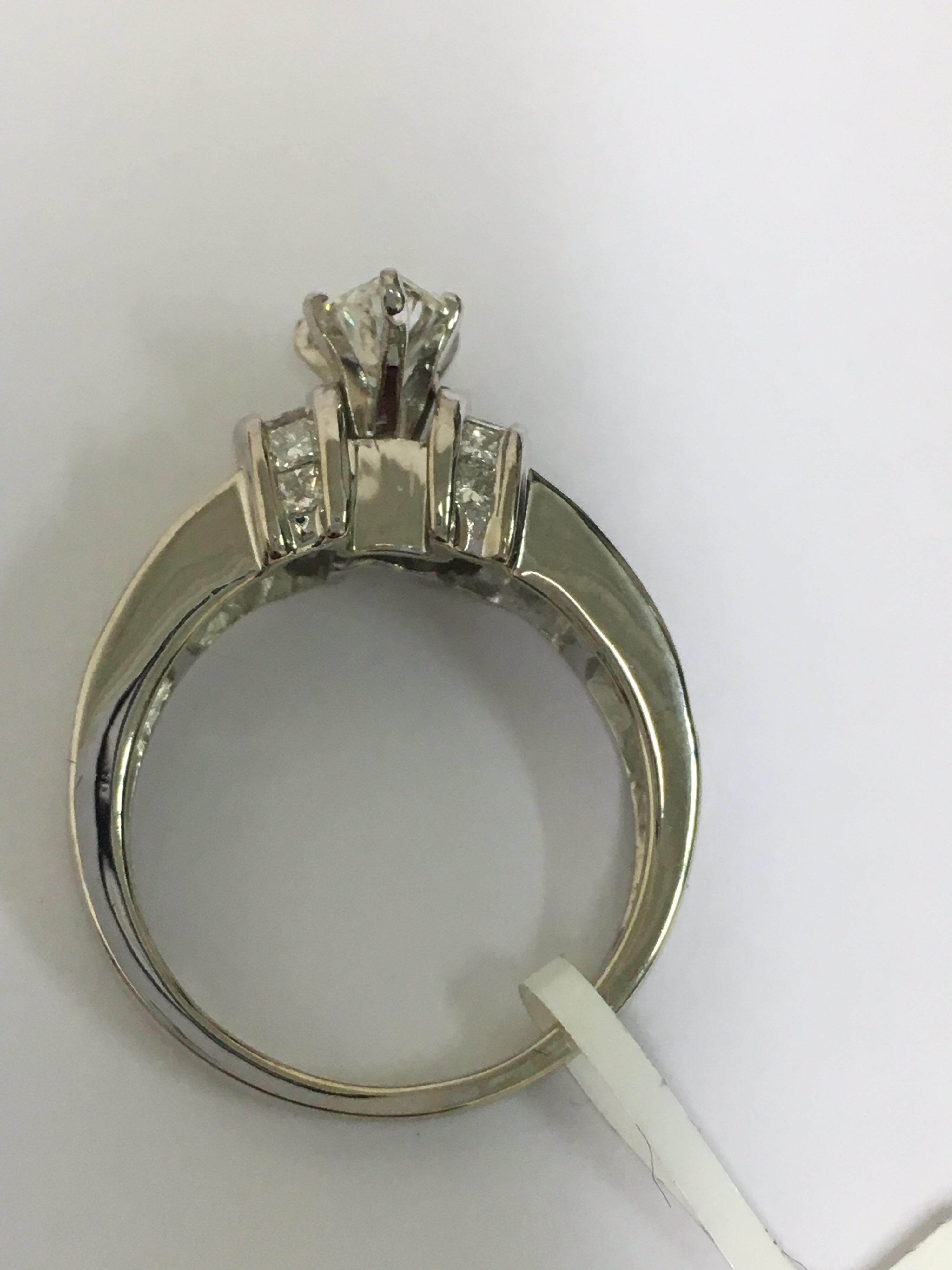 Marquise Diamonds with other diamonds set in 14 Karat White Gold.Center Marquise Diamond is 0.83 Carat and additional approx  1.17 Carat Diamonds which is princess cut and Baguette. Size of the ring is 7 but can be resized.